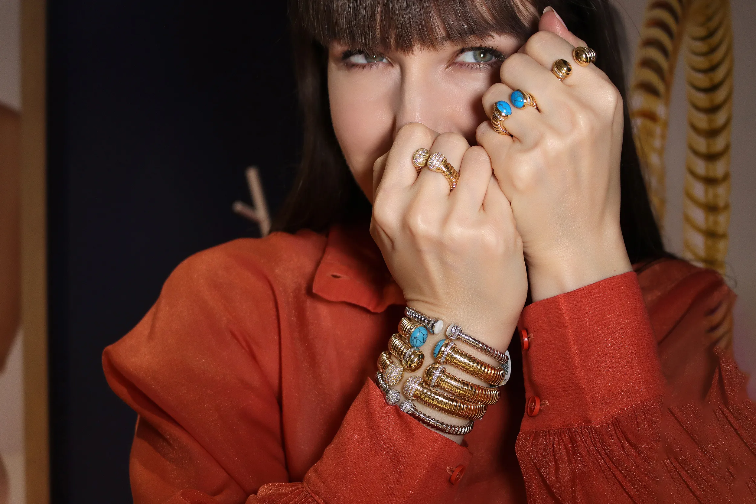 <p>Katerina Perez wears bracelets and rings from the HIMO Jewellery Tourbillon collection, crafted in 18k gold, diamonds and hardstones</p>