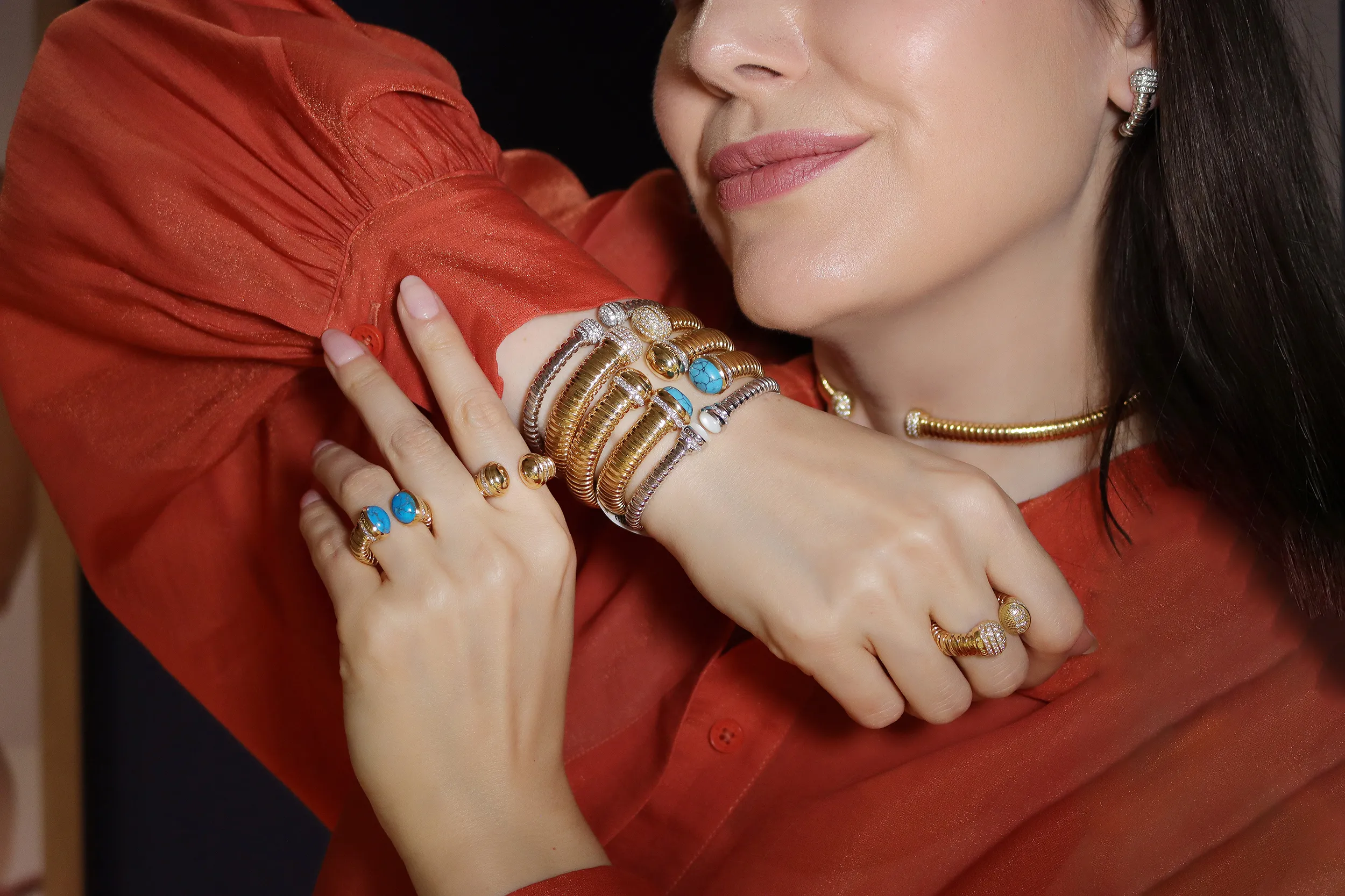 <p>Katerina Perez wears bracelets, rings, a choker and earrings from the HIMO Jewellery Tourbillon collection, crafted in 18k gold, diamonds and hardstones</p>