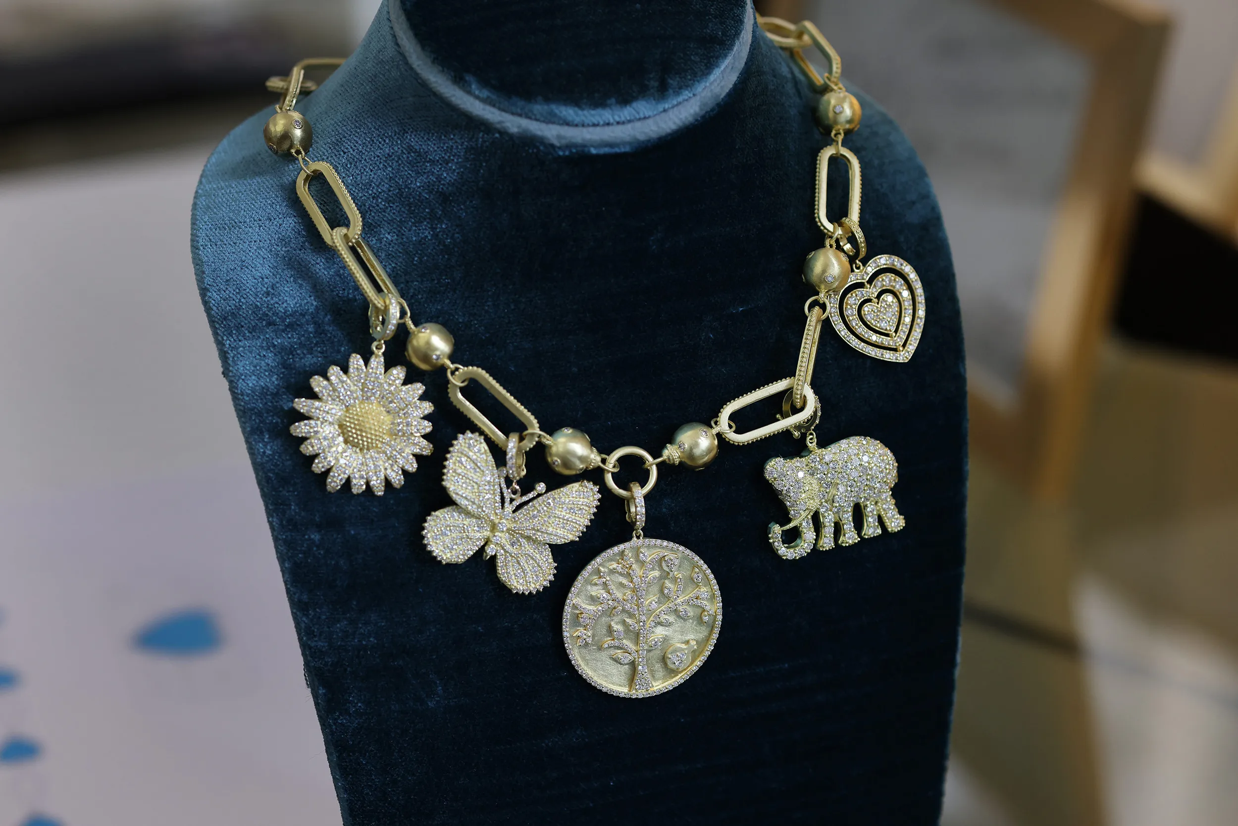 <p>The Tanya Farah Fine Jewelry ‘build your own’ charm necklace with butterfly, elephant, tree of life, heart and daisy-inspired charms with diamonds in 18k yellow gold</p>