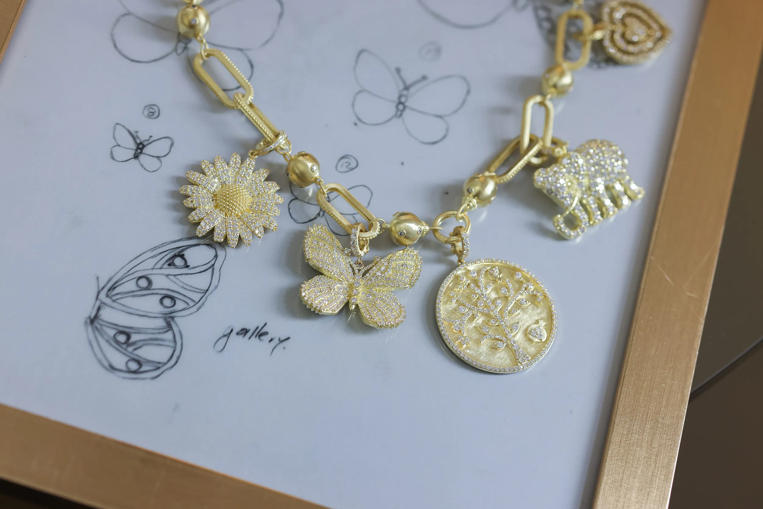 <p>The Tanya Farah Fine Jewelry ‘build your own’ charm necklace with butterfly, elephant, tree of life and daisy-inspired charms with diamonds in 18k yellow gold</p>