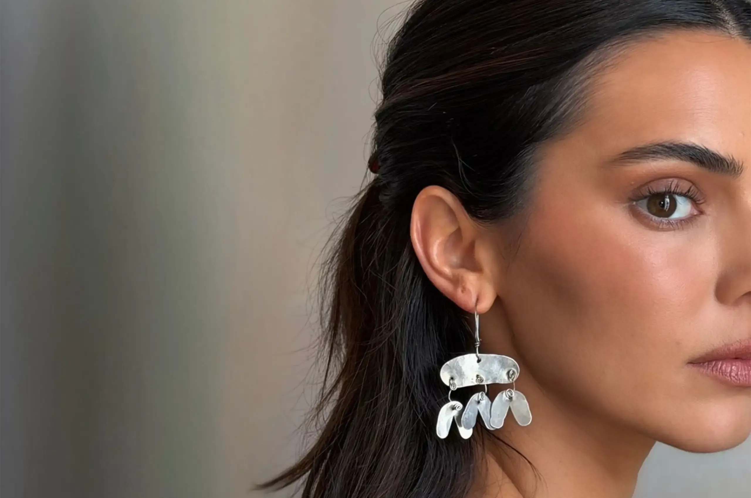 Kendall Jenner wears rare Alexander Calder earrings from 1955, hand formed in hammered silver and steel wire and sourced through London gallerist Louisa Guinness.