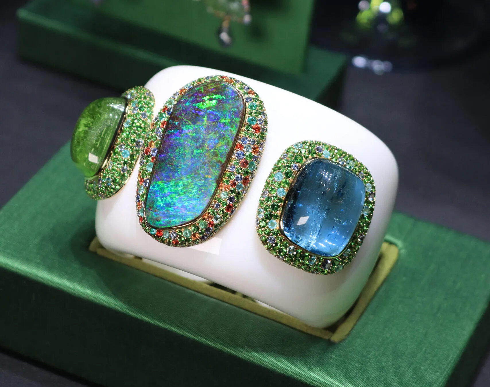 <p>Margot McKinney Lagoon cuff with a 54.25 carat Australian boulder opal, a 64.35 carat aquamarine, and a 78.28 carat peridot surrounded by white opal, blue sapphires, orange sapphires, Paraiba tourmalines, and tsavorites, set in 18k white and yellow gold </p>
