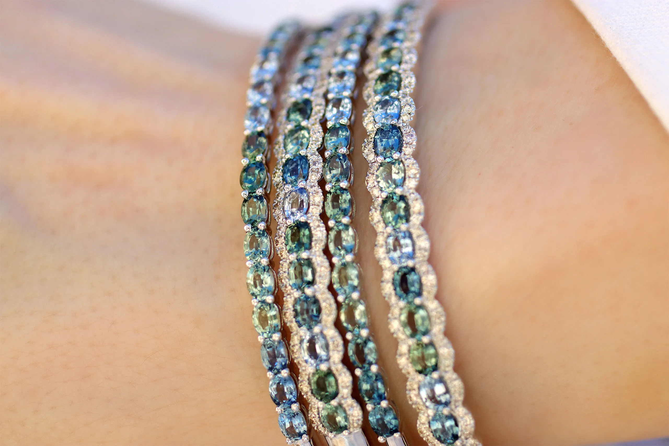 <p>Tennis-style bracelets from the Le Vian Montana Sapphire Ombré™ Collection, including a pair of bangles accented with Nude diamonds™ set in 14K Vanilla Gold®</p>