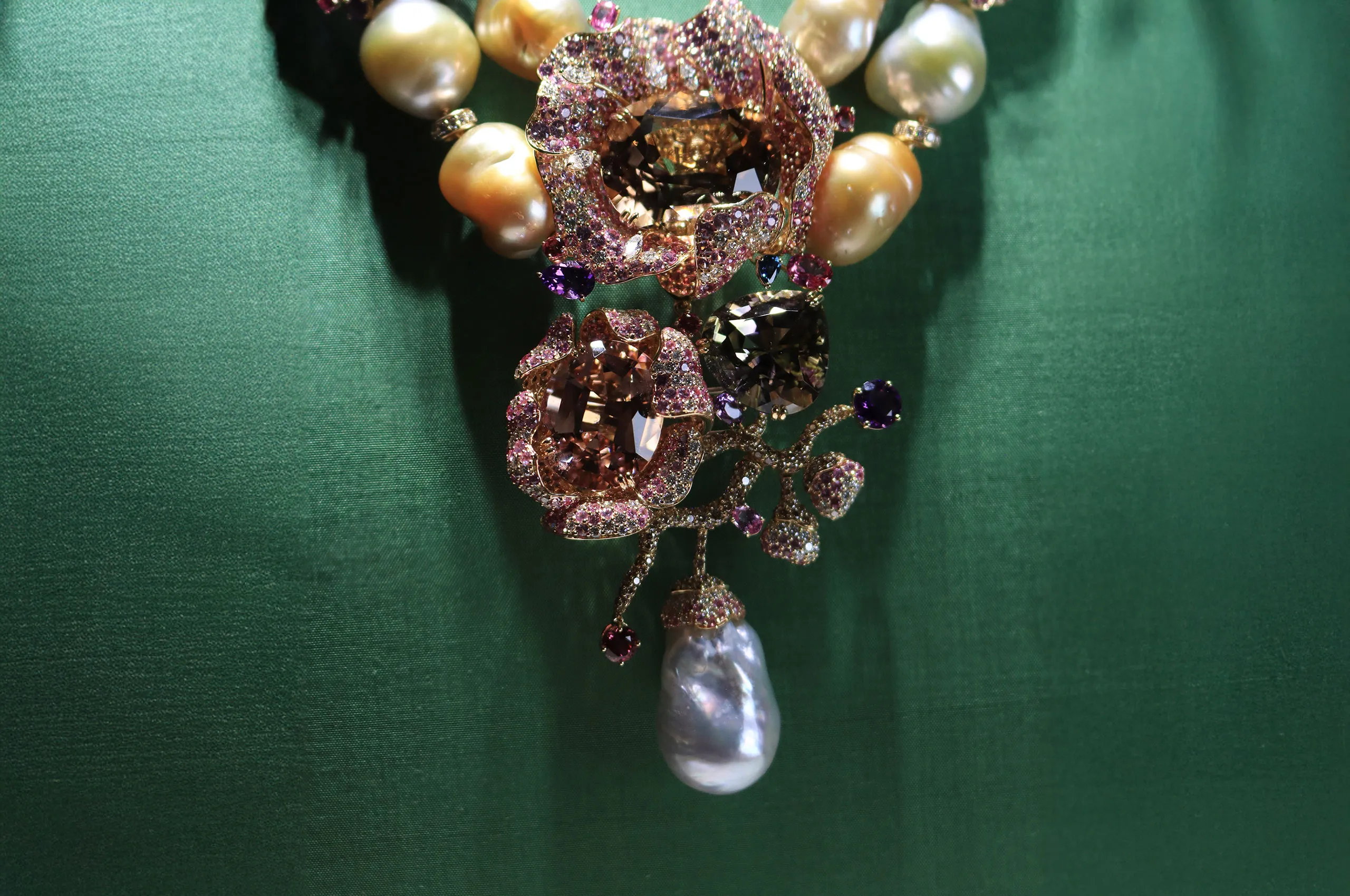 <p>The focal point of the Margot McKinney Bloem collier with a 65.85 carat tourmaline, Australian South Sea baroque pearls, and a mixture of white diamonds, brown diamonds, blue, pink and purple sapphires, pink tourmalines, amethysts and rubellites, set in 18k yellow gold </p>
