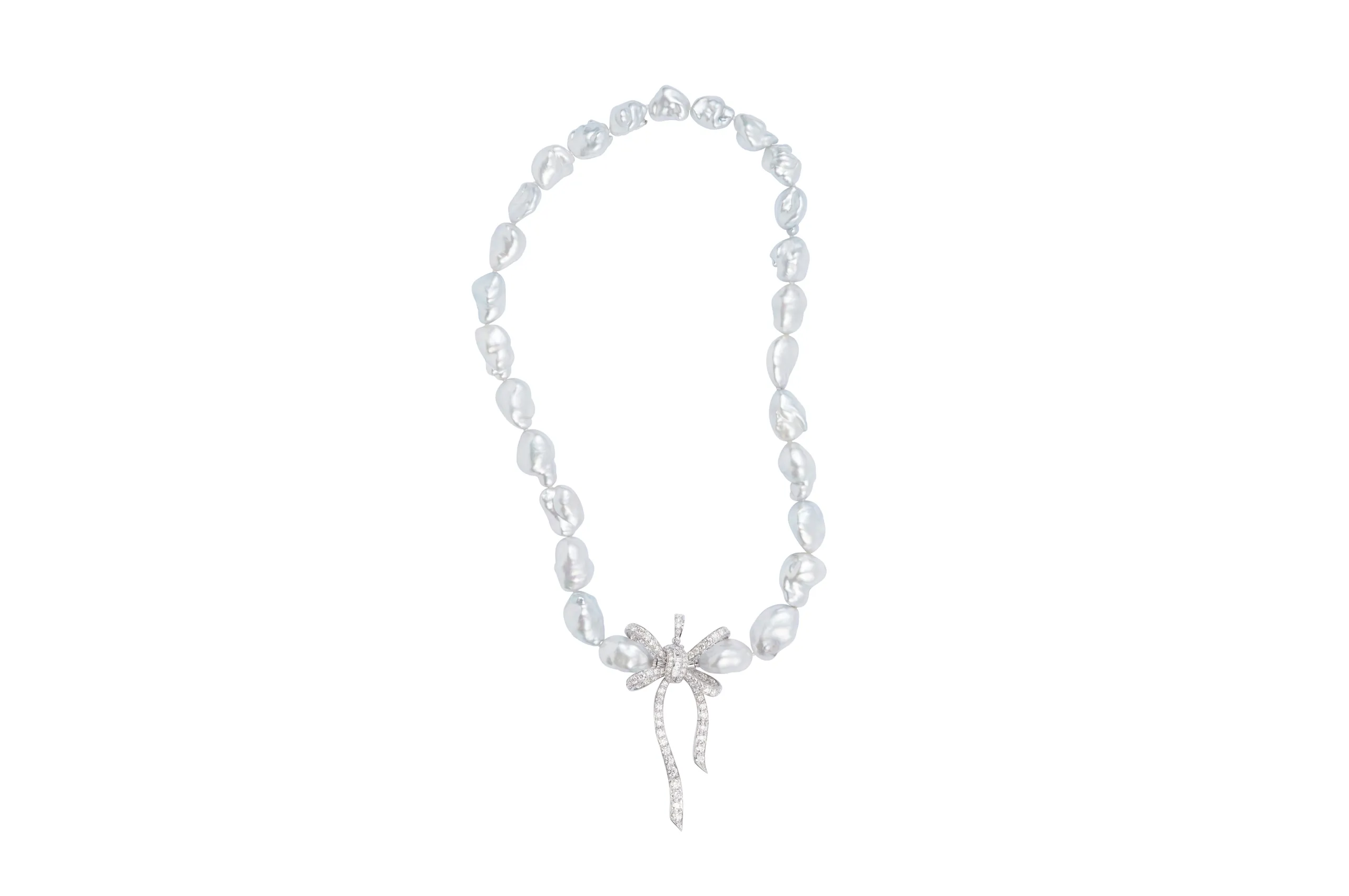<p>Margot McKinney Bow pendant with diamonds in 18k white gold, shown here with a necklace of Australian South Sea baroque pearls</p>
