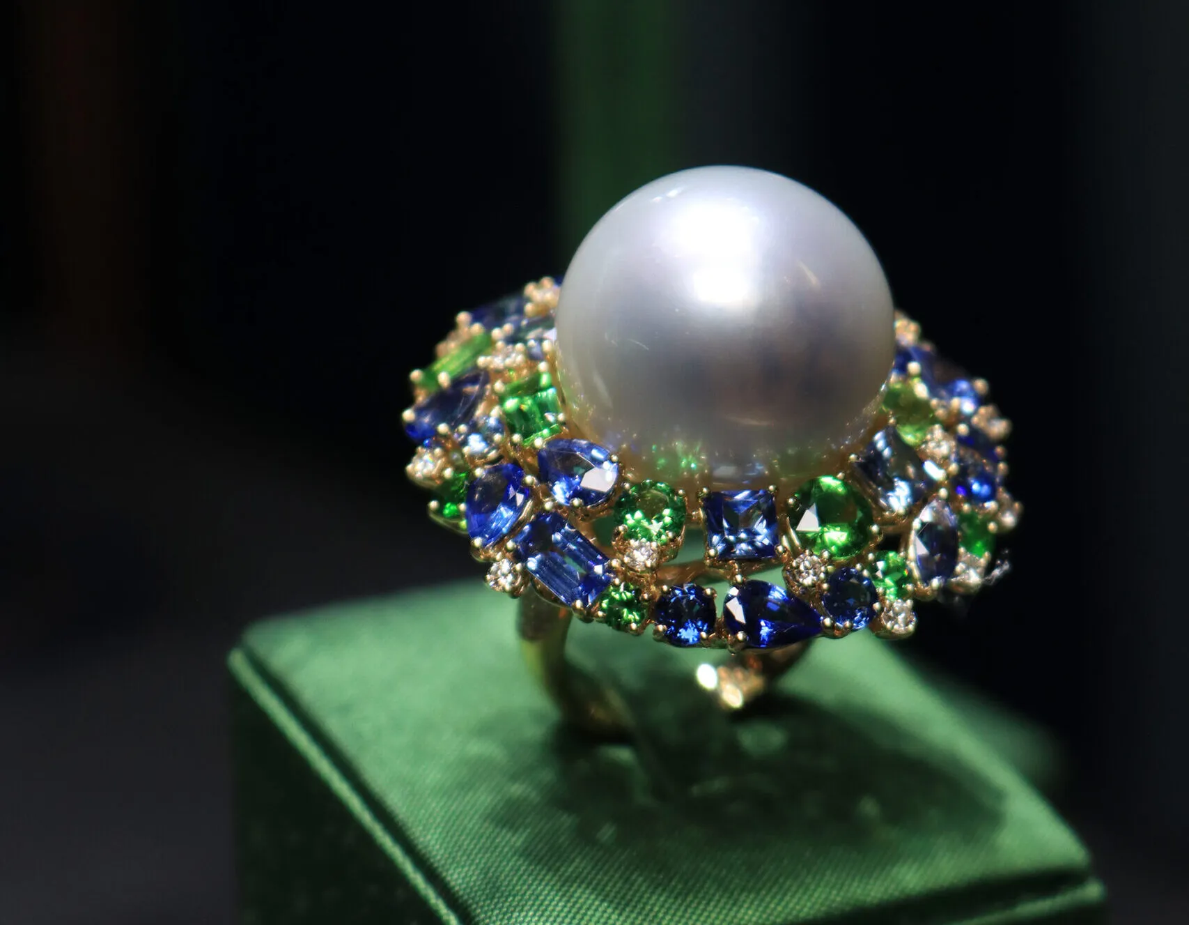 <p>Margot McKinney Swirl ring with Australian South Sea pearls, diamonds, pink sapphires, purple sapphires, tsavorites and peridots set in 18k yellow and white gold</p>
