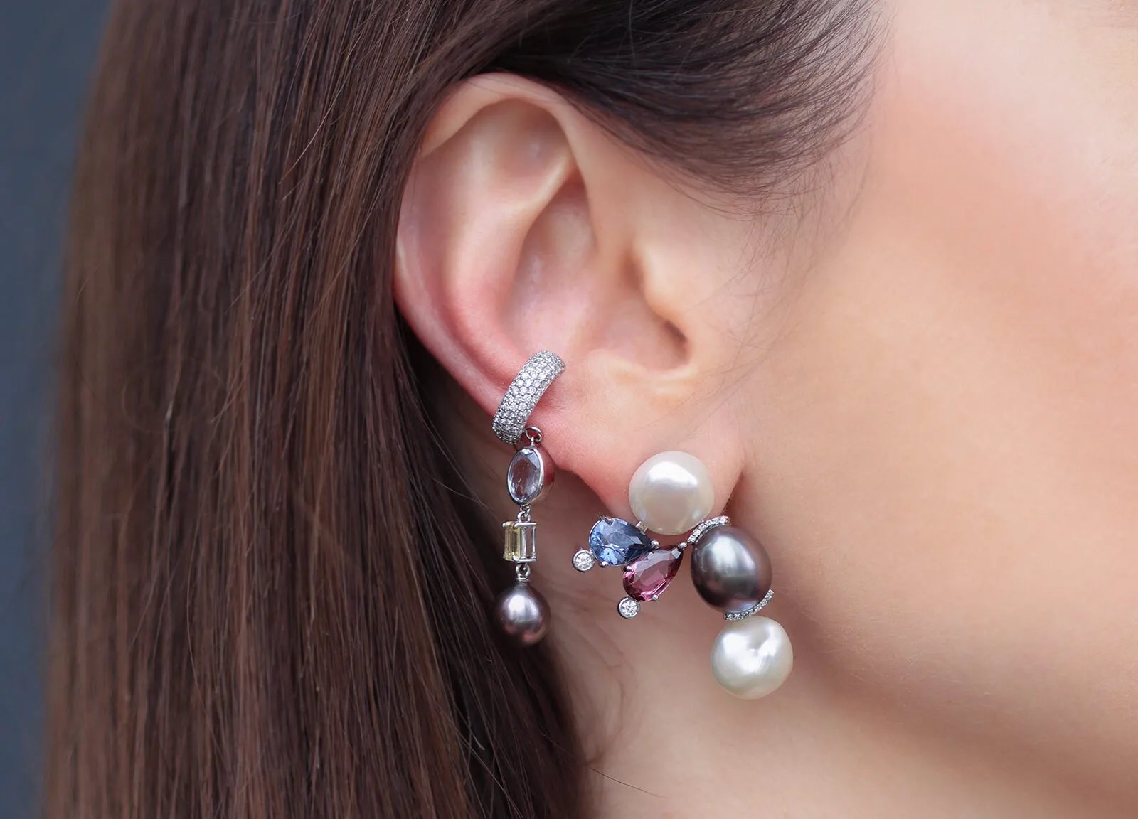 <p>Mariyeh Ghelichkhani Bumble Bee earring from the Insect collection with a freshwater pearl, Tahitian pearl, purple and maroon spinels, and diamonds, pictured here alongside a diamond-set huggie and drop earring </p>
