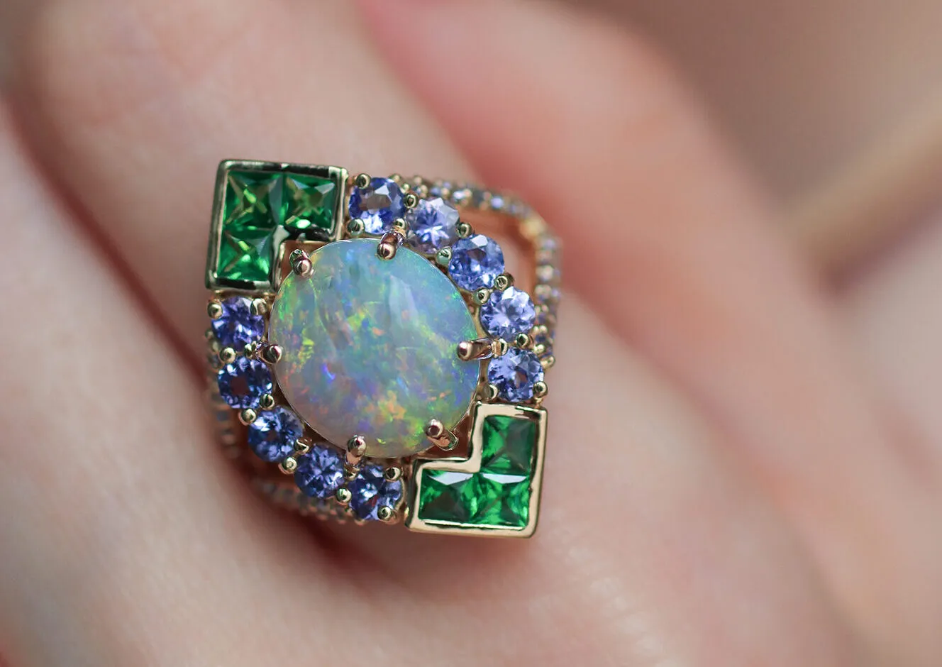 <p>Mariyeh Ghelichkhani Angels Fall ring with a round-shaped Australian opal cabochon, tsavorites and tanzanites set in 18k yellow gold </p>
