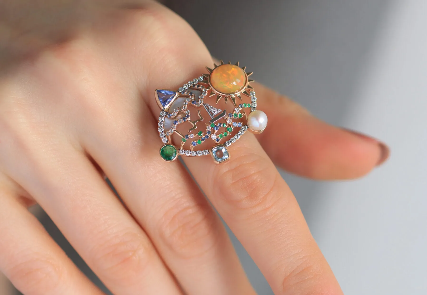 <p>The Mariyeh Ghelichkhani Serene Voyage ring conjures an ocean scene with a precious opal, diamonds, coloured sapphires, emerald, mother of pearl and a single round pearl set in 18k yellow gold </p>
