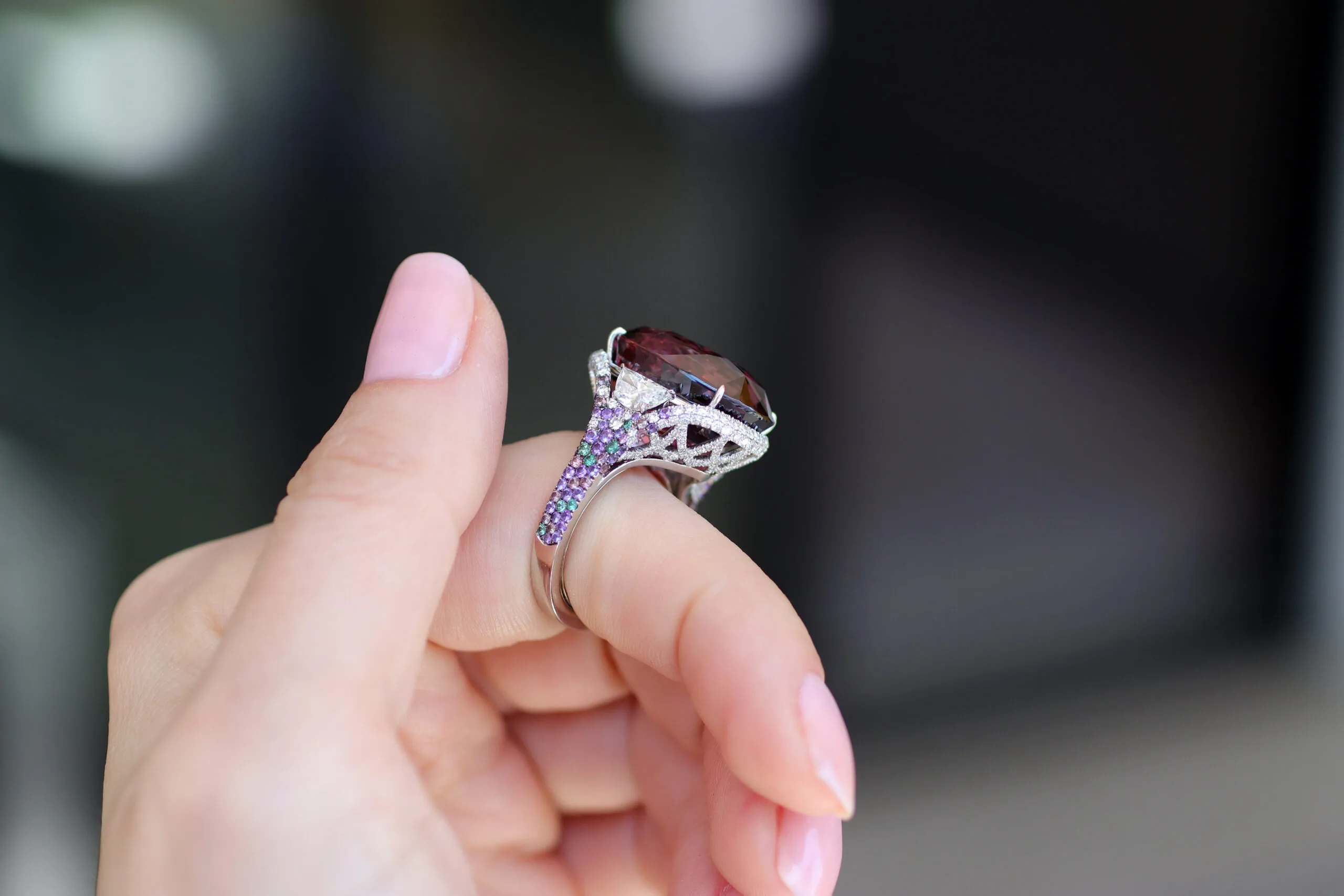 <p>Martin Katz ring with a 33-carat unheated bluish pink oval-shaped sapphire, accented by two half-moon diamonds and 319 micro-set gemstones, including lavender sapphires, amethysts, and colour change garnets</p>
