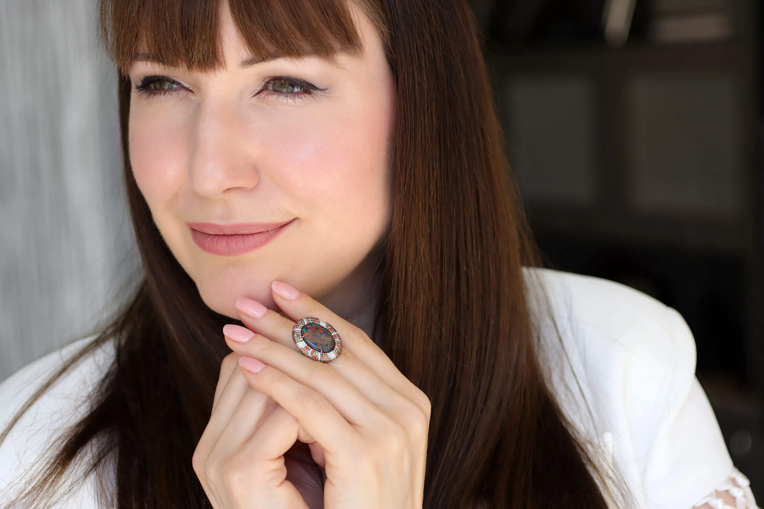 <p>Katerina Perez wears a right-hand ring by Martin Katz, set with a 6.80-carat oval-shaped Australian black opal, diamonds, sapphires and tsavorites in platinum</p>
