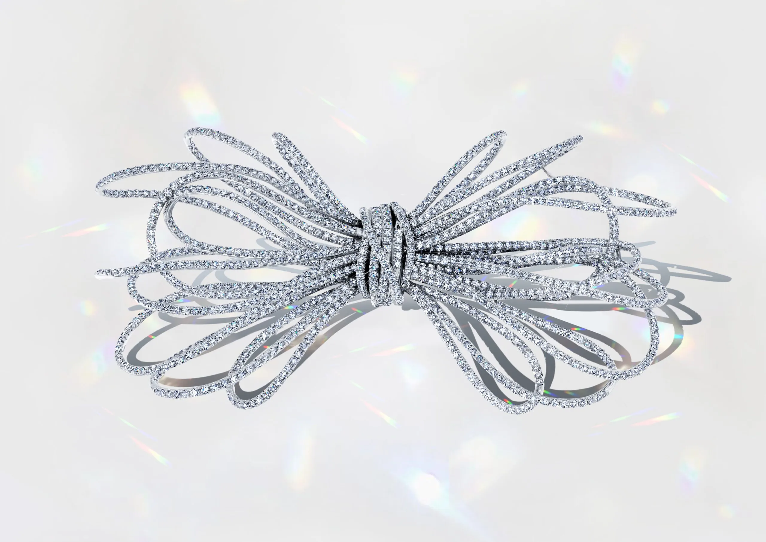 <p>Martin Katz Anniversary Diamond Bow pin featuring 1,137 diamonds, weighing over 13 carats, inspired by the fluid lines of shredded paper ©martinkatzjewels</p>

