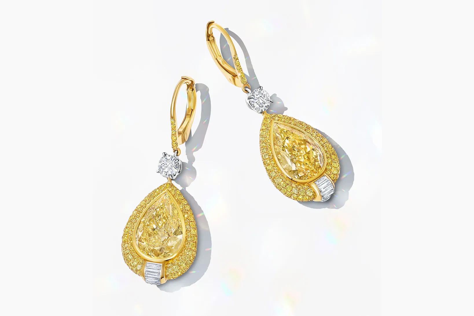 <p>Martin Katz earrings with fancy yellow pear-shaped diamonds totalling 8 carats, accented with two round diamonds, 12 channel-set baguette diamonds, and micro-set with 404 fancy yellow diamonds, set in 18k yellow gold ©martinkatzjewels</p>
