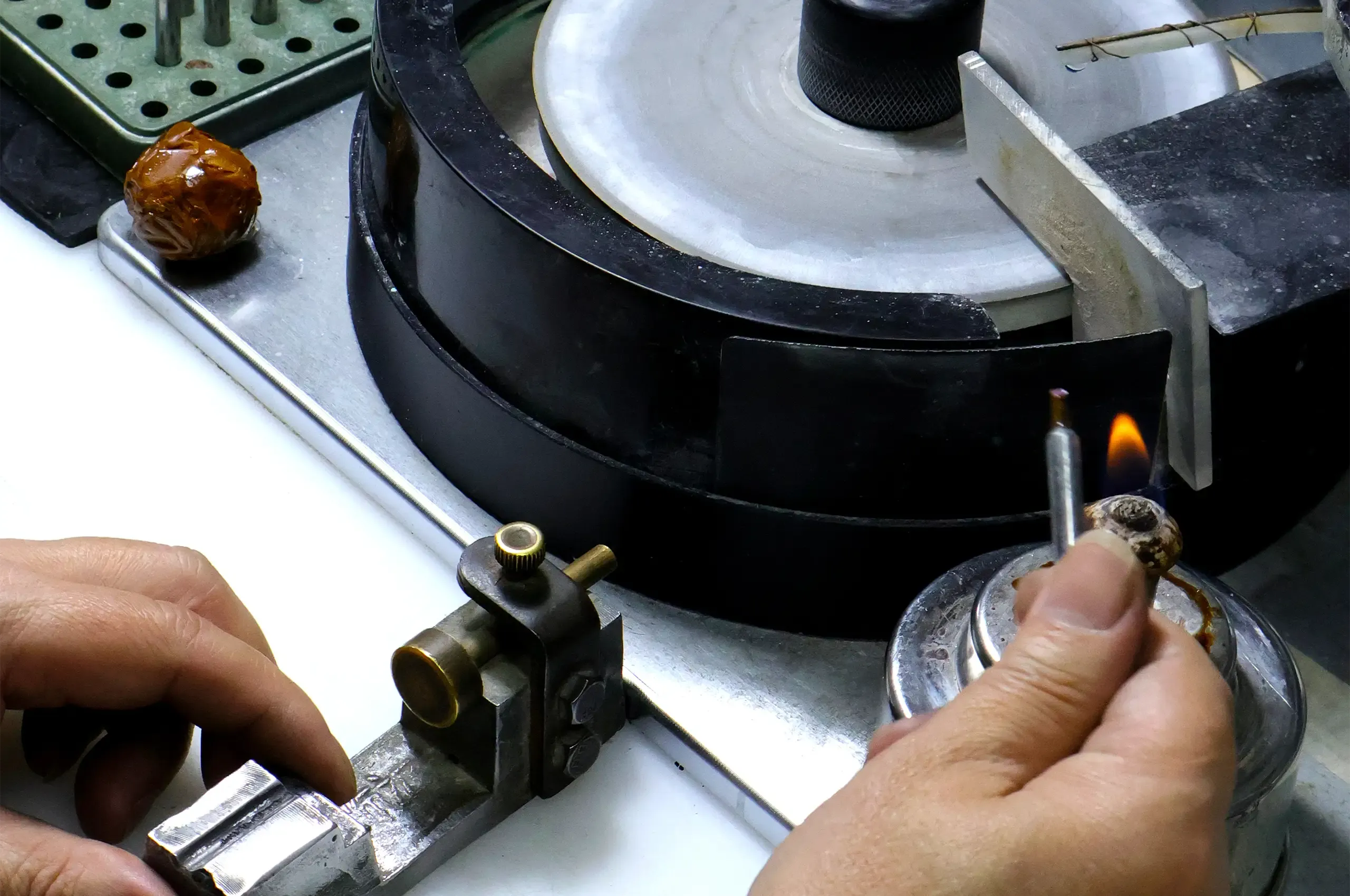 A gem cutter, preparing to polish a gemstone