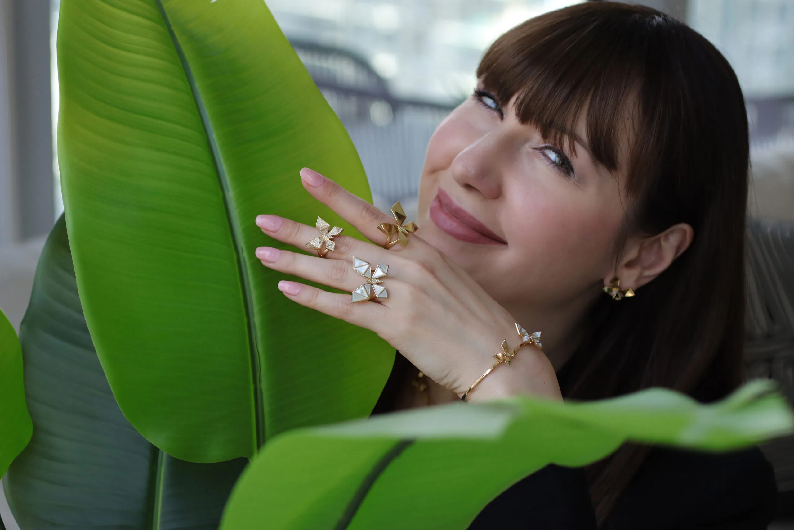 <p>Katerina wears jewels from NTERDI’s Vol O Vent Collection, which distil the essence of a butterfly into sharply geometric forms in 18k yellow gold, diamonds and mother-of-pearl that resemble elegant origami sculptures</p>
