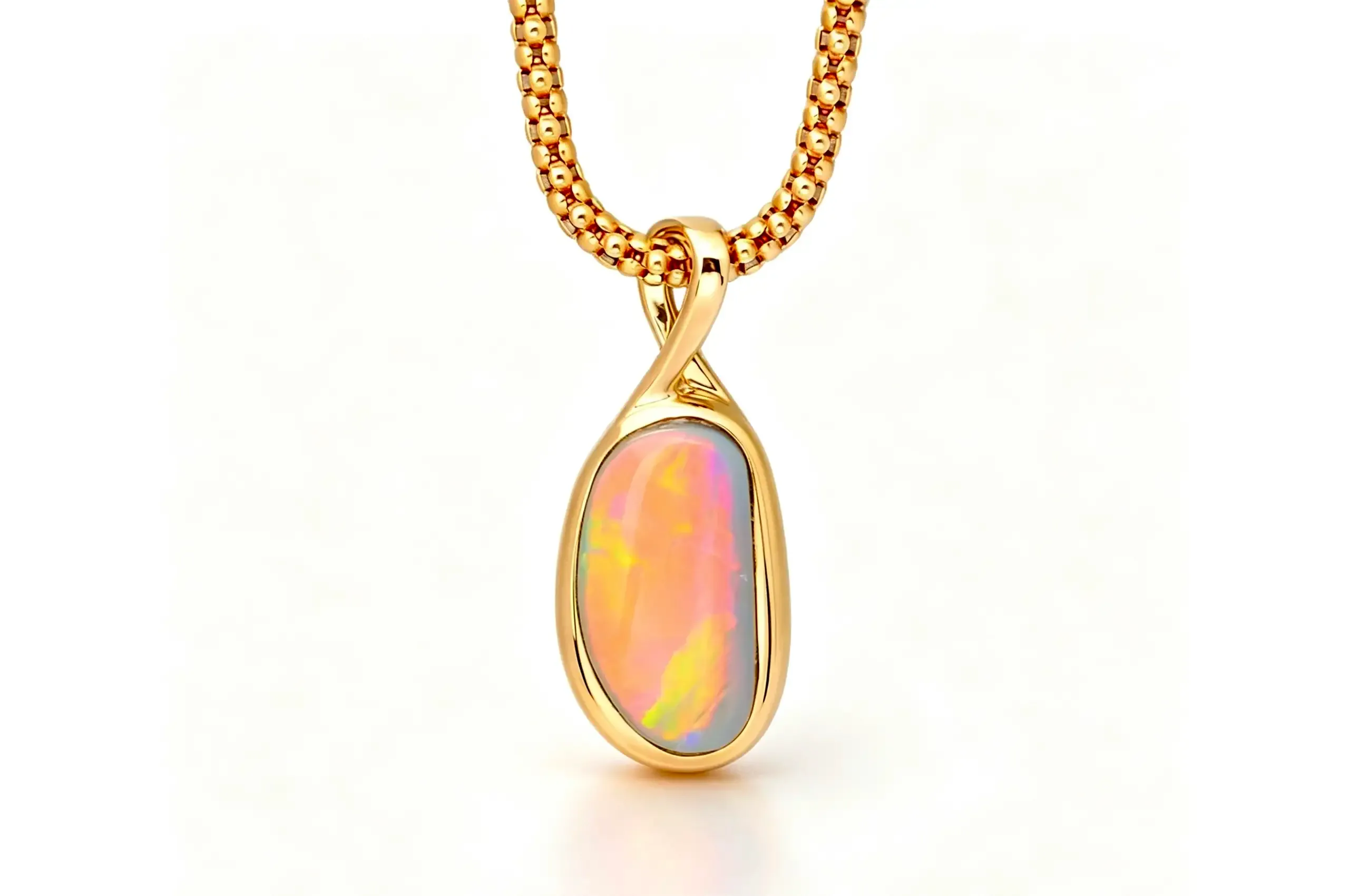 Olivia Chan Pastel Fire black opal pendant set with a 1.38 carat Australian black opal with soft pink, peach and golden play-of-colour, bezel-set in 18k yellow gold 