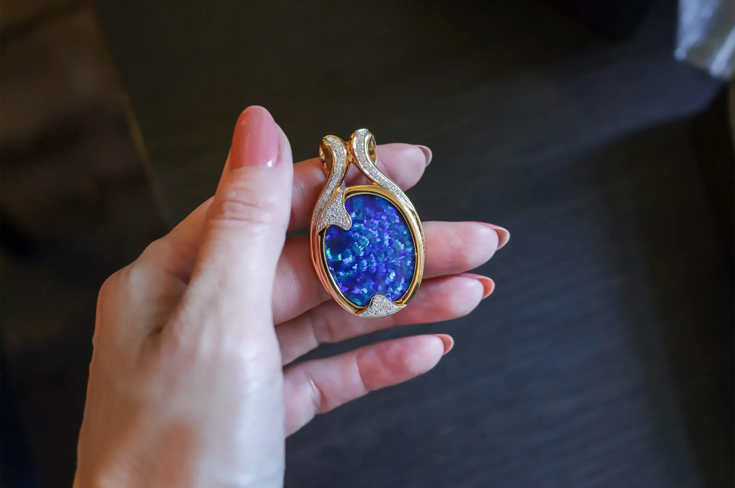 Set in 18k yellow gold, Olivia Chan’s 36.80-carat Australian black opal pendant takes its design cues from the stone’s rare Peacock Tail pattern