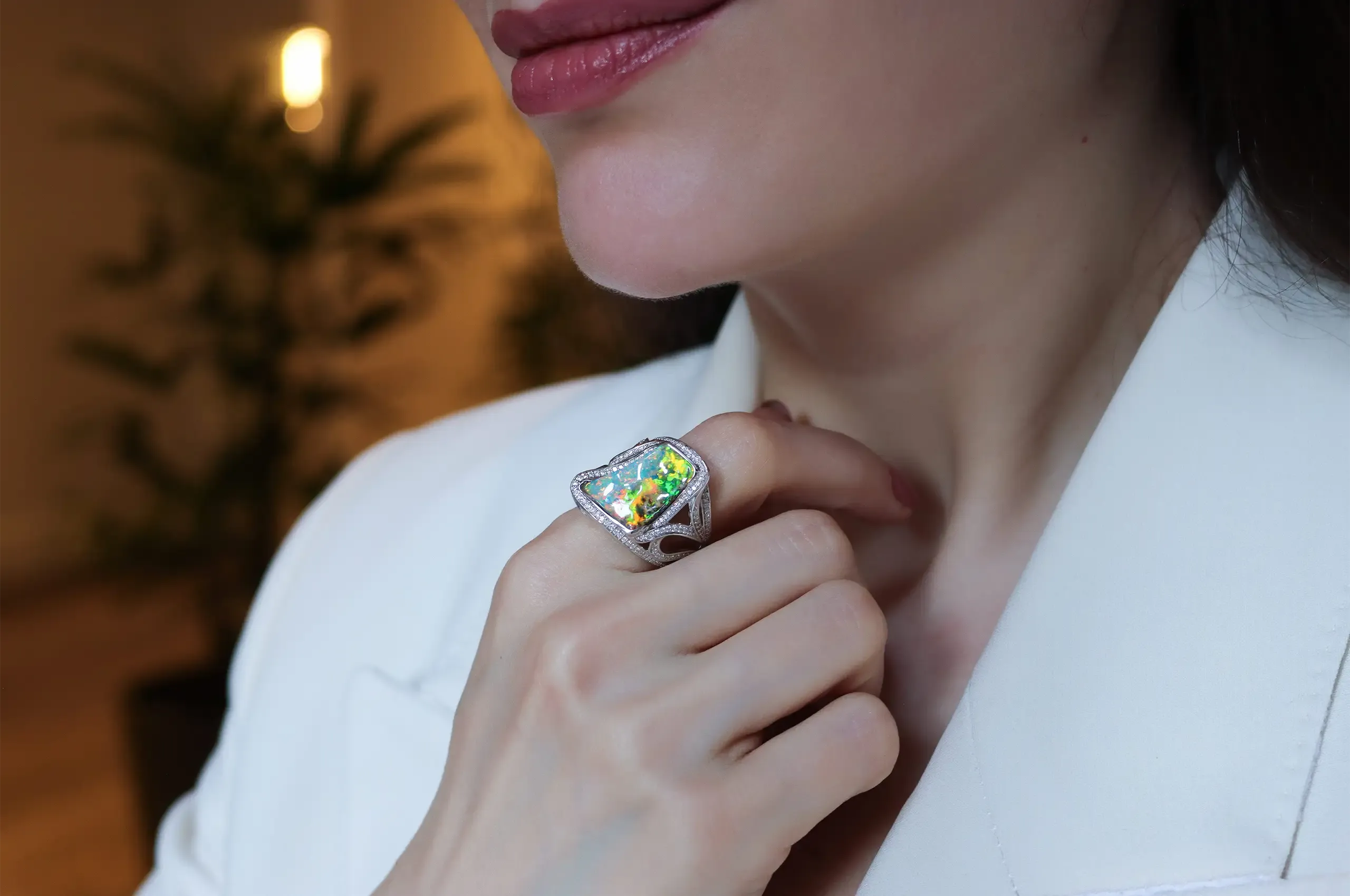 Flashes of green, blue and orange illuminate an 8.40-carat Australian boulder opal ring by Olivia Chan, set with 0.80 carats of diamonds in 18k white gold