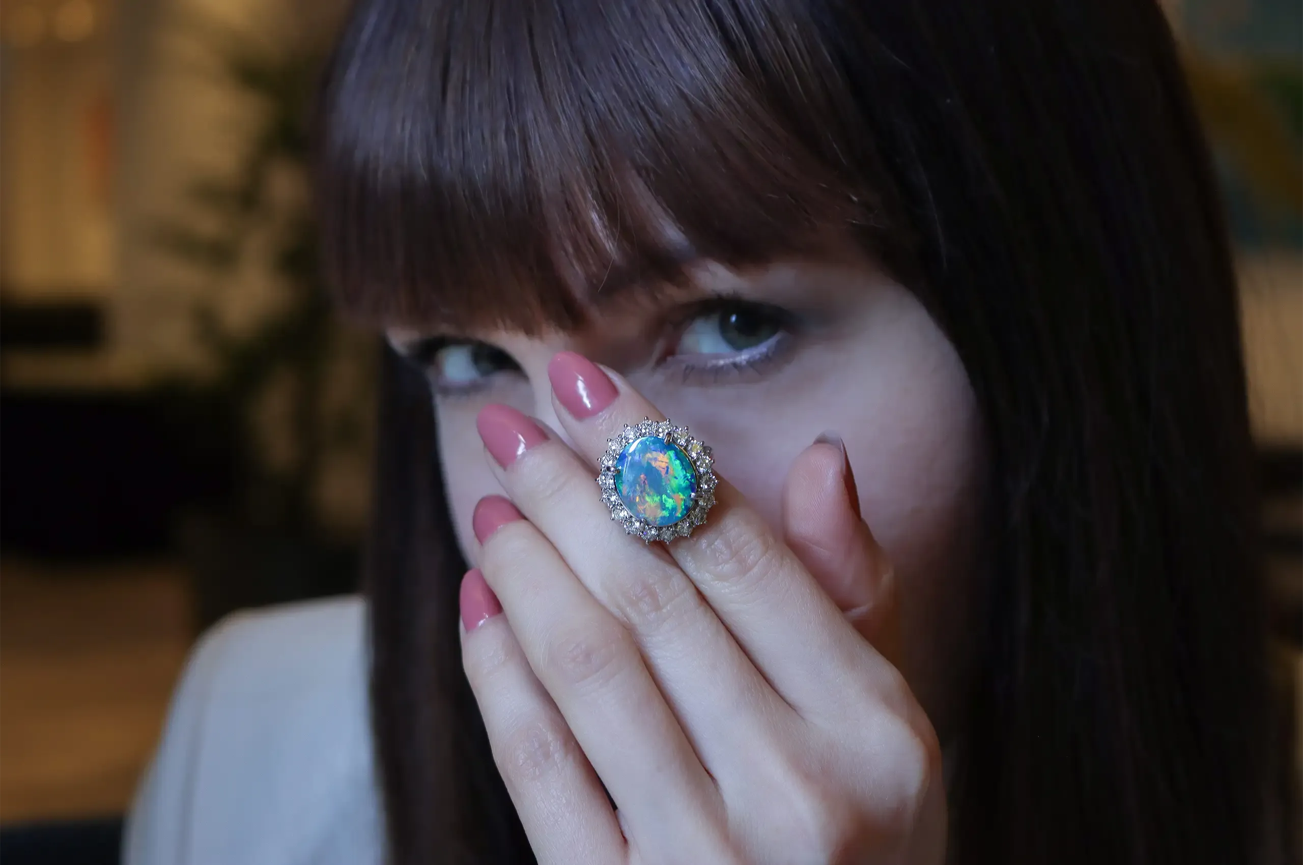 Blue, green and a flash of pink sweep across this 7.86-carat Australian black opal, set in an 18k white gold ring by Olivia Chan