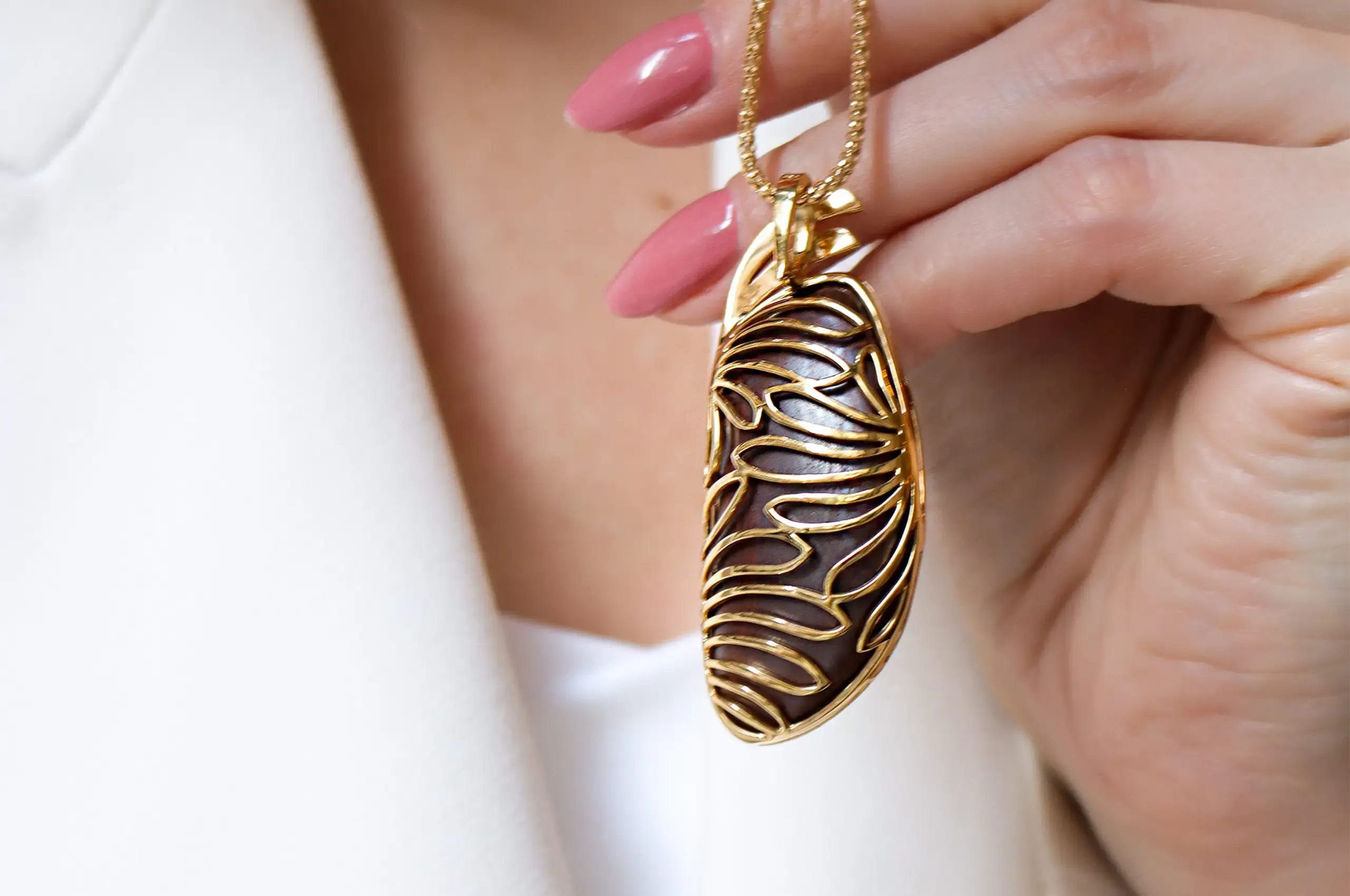 The reverse of Olivia Chan’s boulder opal pendant reveals the sculptural 18k yellow gold setting created around the 65.23-carat stone