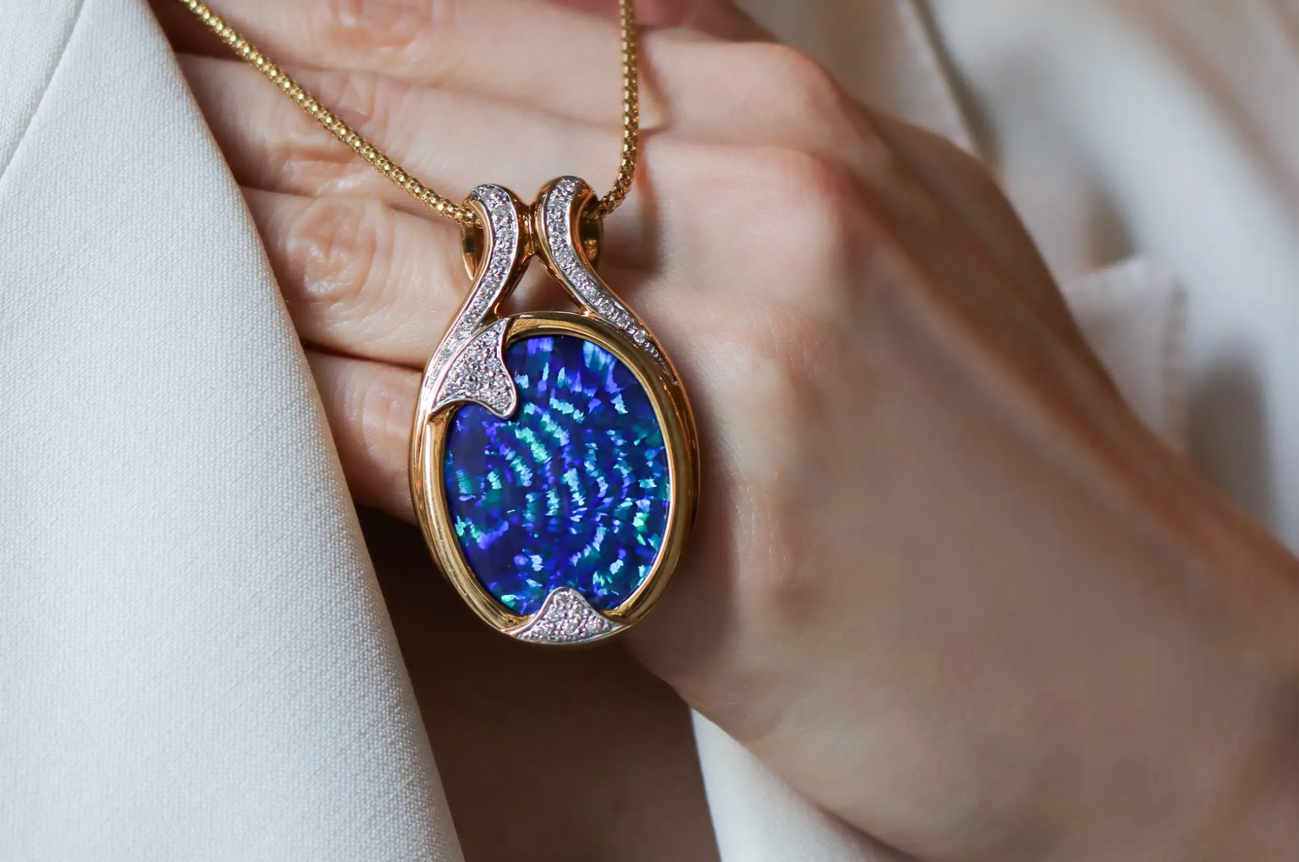 A rare Peacock Tail pattern fans across this exceptional 36.80-carat Australian black opal pendant by Olivia Chan