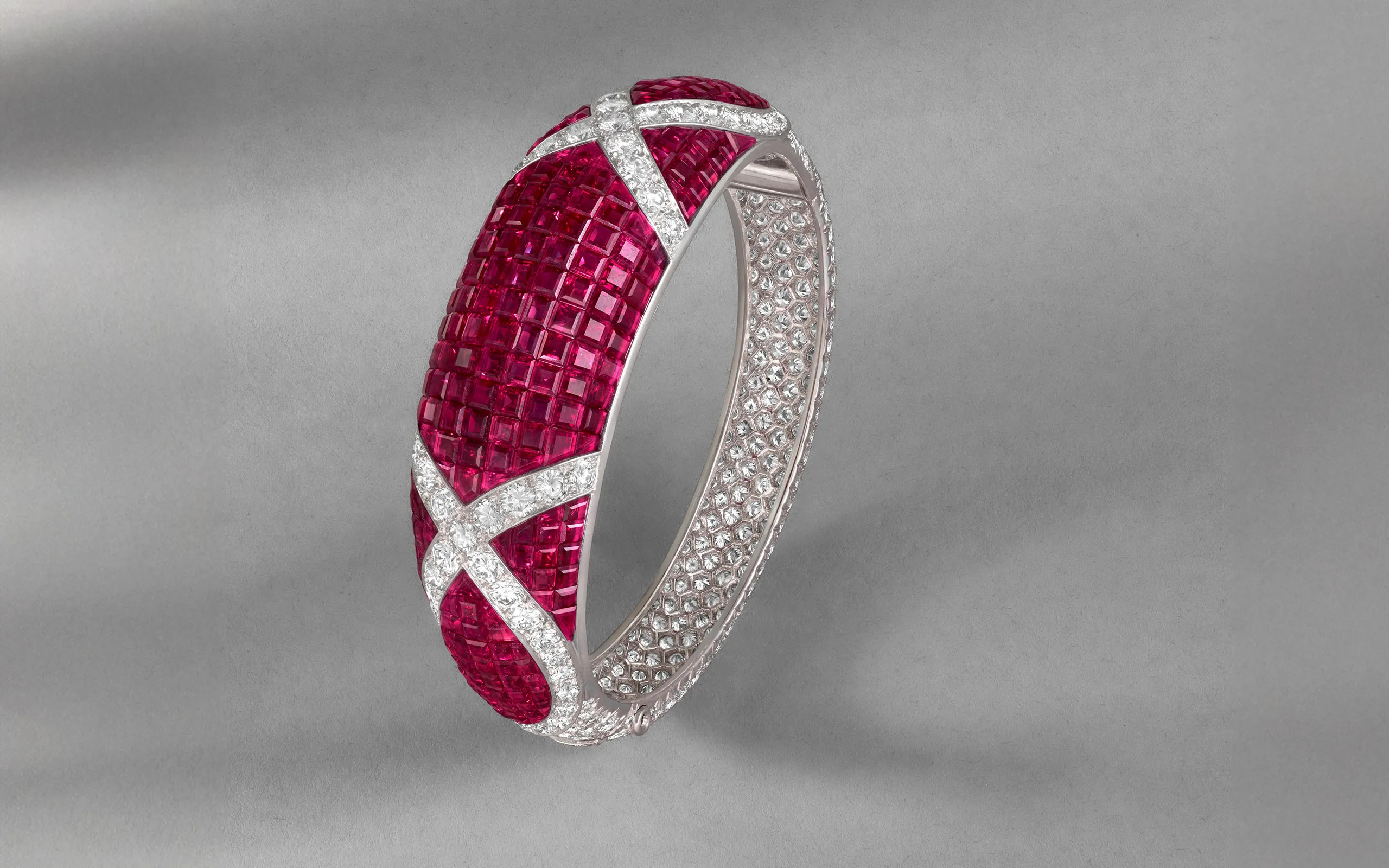 <p>Van Cleef & Arpels Orsay bracelet with mystery-set rubies and diamonds in platinum and yellow gold (c. 1994), to be presented at TEFAF Maastricht 2025</p>