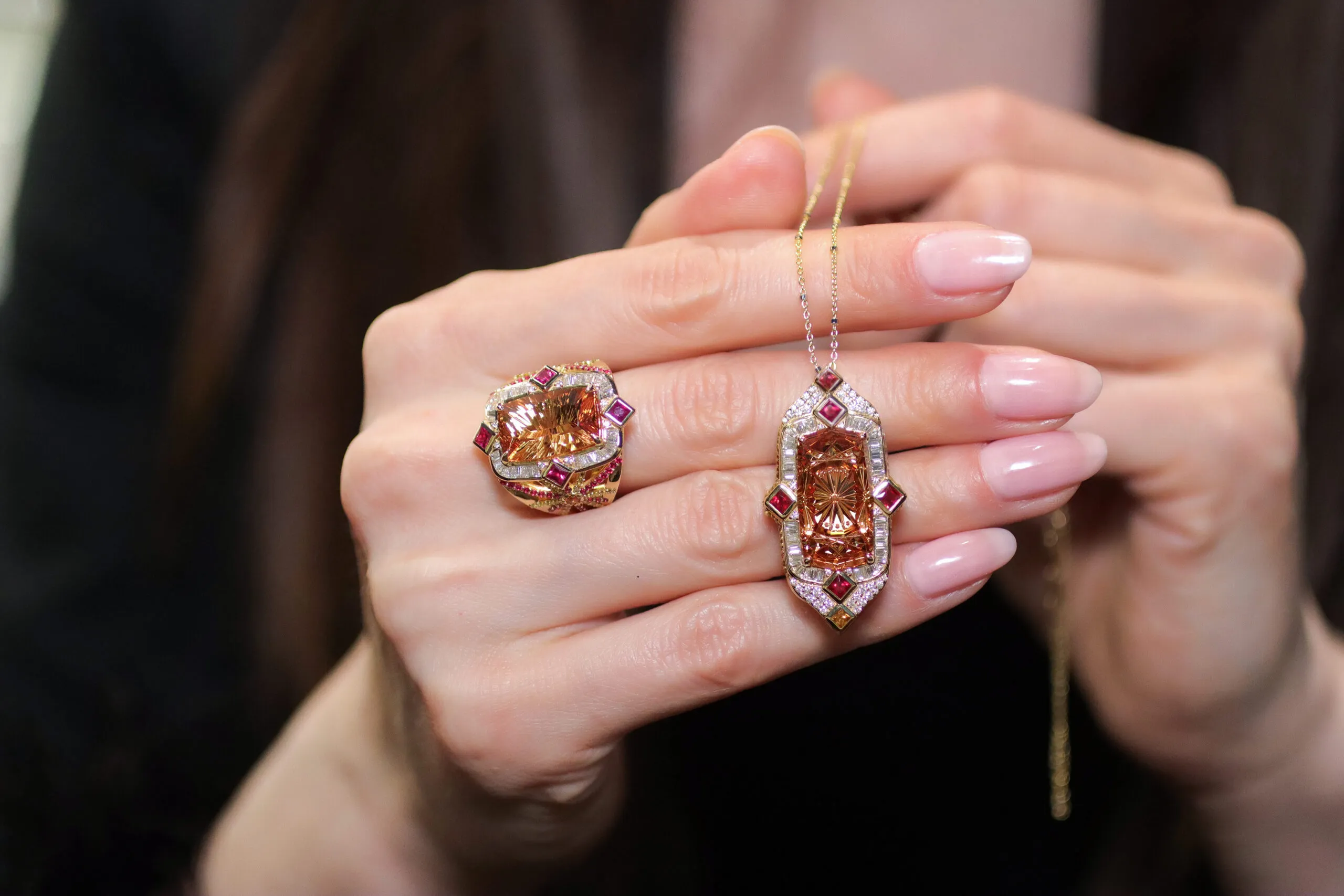 <p>Palm Beach Gems by Nicole Deco Soleil South Beach pendant and matching ring, designed by Robin Callahan, featuring fantasy carved orange Imperial topazes by Dalan Hargave, alongside rubies, and diamonds, set in 18k yellow gold</p>
