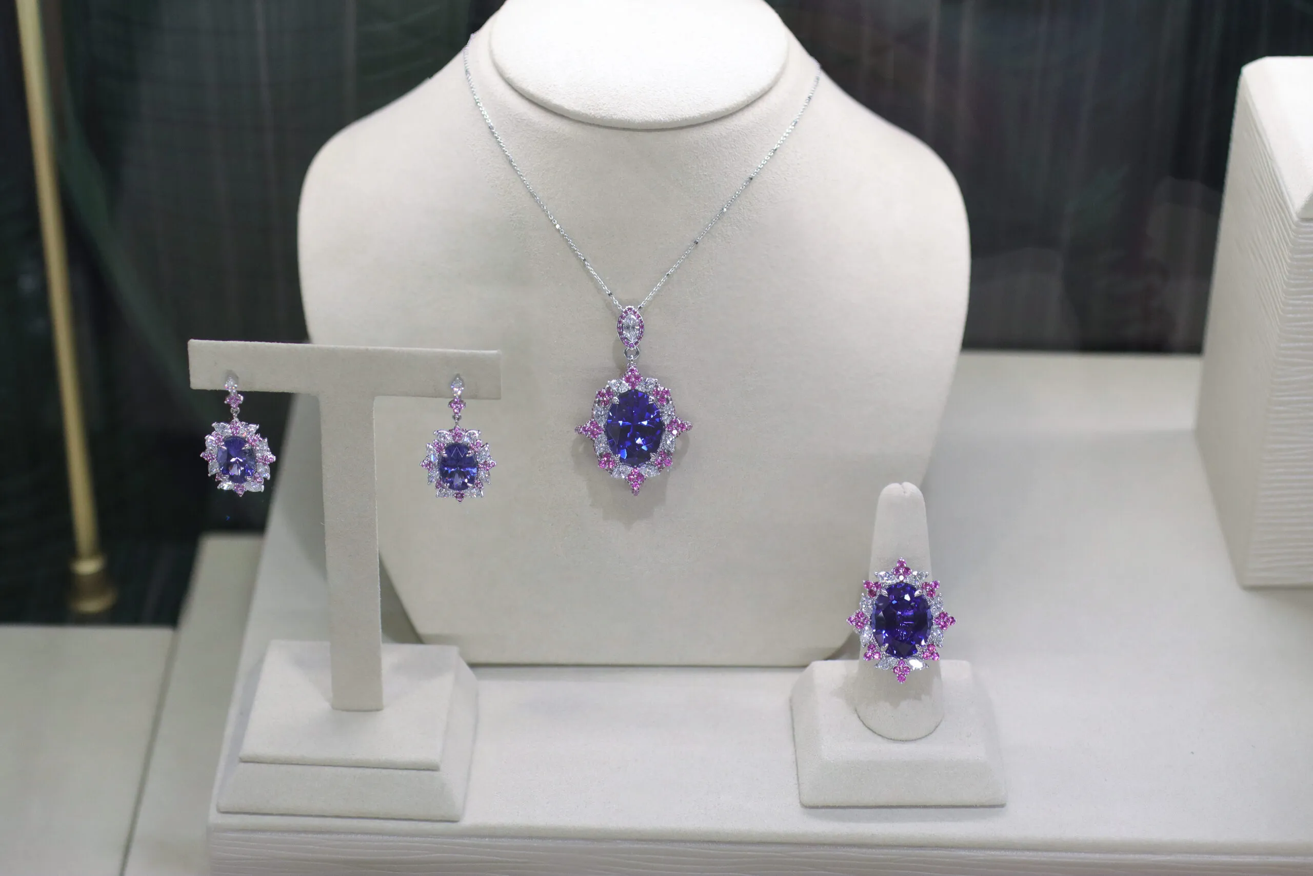 <p>Palm Beach Gems by Nicole Imperial Bloom suite, designed by Robin Callahan, including a pendant, ring and a pair of earrings set with oval-shaped tanzanites, diamonds and pink sapphires in 18k white gold</p>