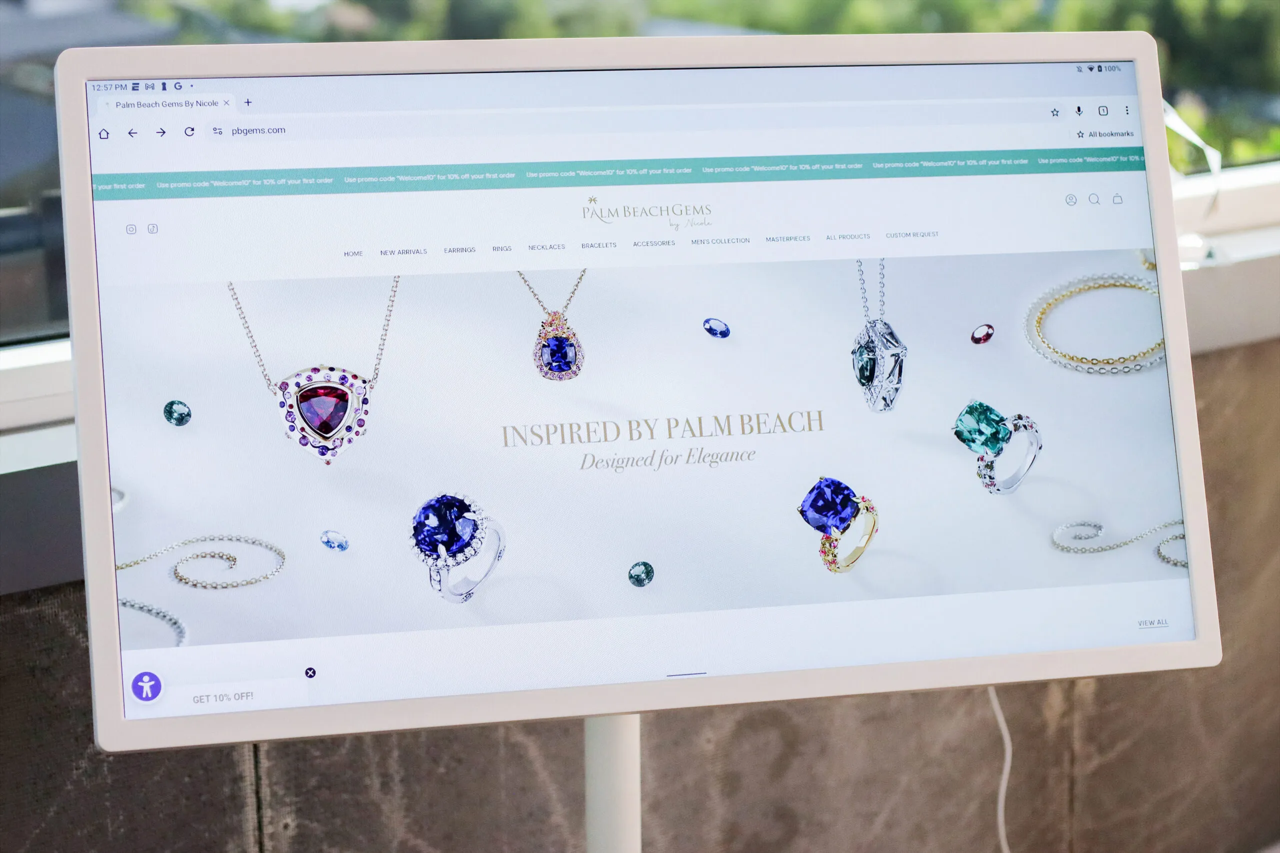<p>A digital screen allowing clients to view the Palm Beach Gems by Nicole website in store</p>