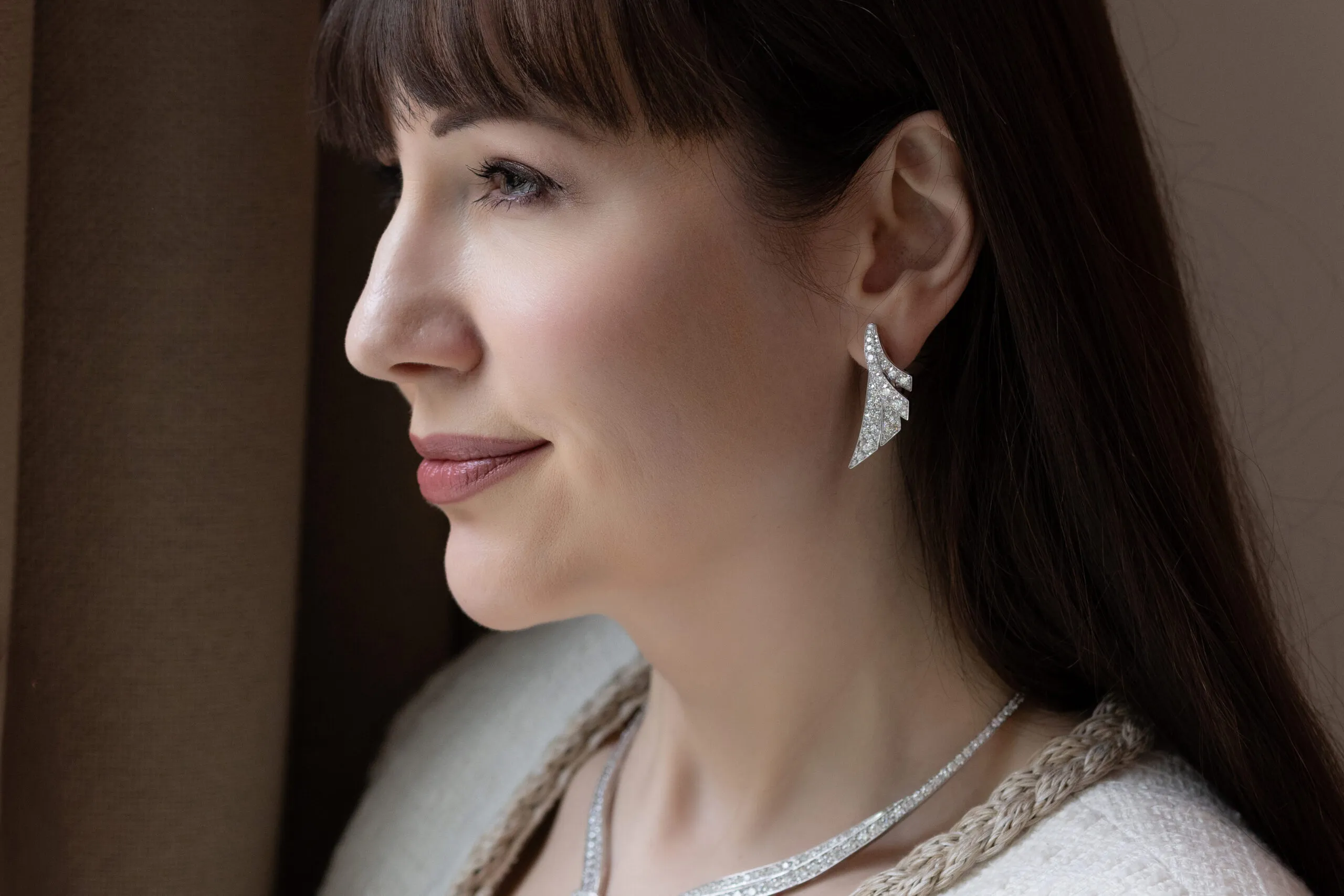 <p>The matching Diamond Embrace earrings feature the same tapering silhouette, allowing the serpentine lines of the necklace to echo across the suite</p>
