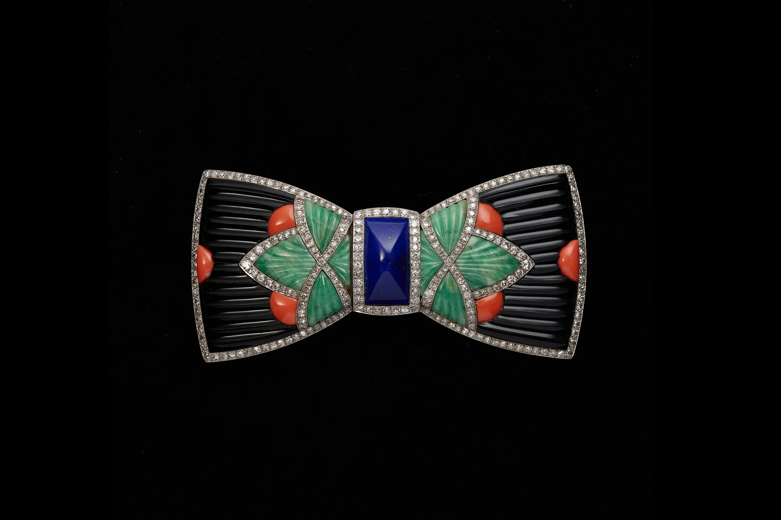 <p>Lucien Hirtz for Boucheron Bow tie brooch in platinum, onyx, coral, jade, lapis lazuli and diamonds, exhibited at the 1925 Exposition internationale des arts décoratifs et industriels modernes in Paris, from the Collection of Neil Lane. Photograph © Lendon Flanagan</p>
