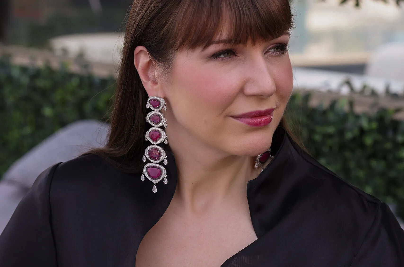 <p>Katerina Perez wears the Ruby Strata earrings by Renu Oberoi set with 34.15 carats of flat-cut Mozambique rubies surrounded by 11 carats of diamonds in 18k gold</p>

