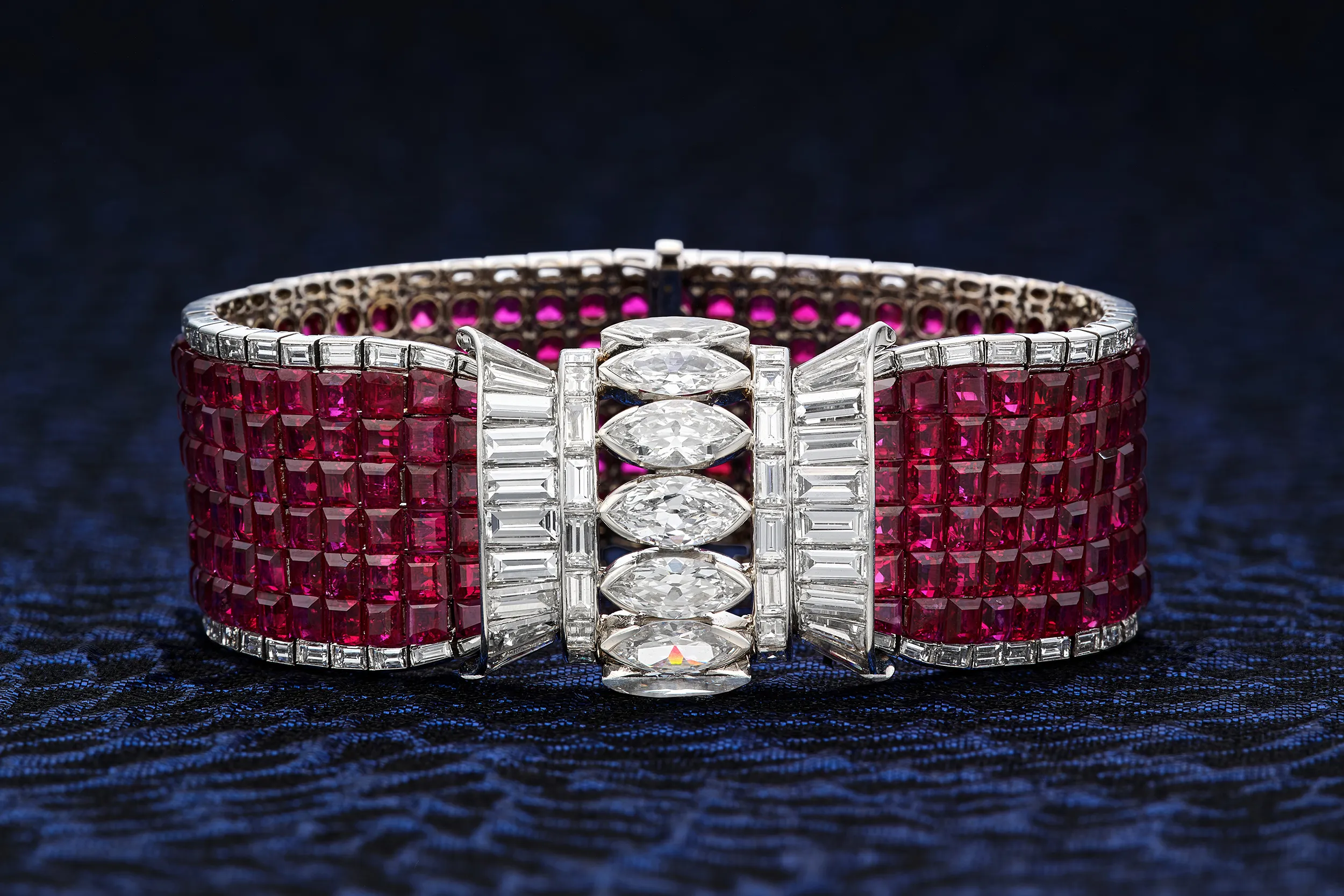 <p>Cartier bracelet in a flexible strap of calibré-cut rubies bordered by baguette diamonds, with a central row of marquise-shaped diamonds set between straight and tapered baguette diamonds</p>