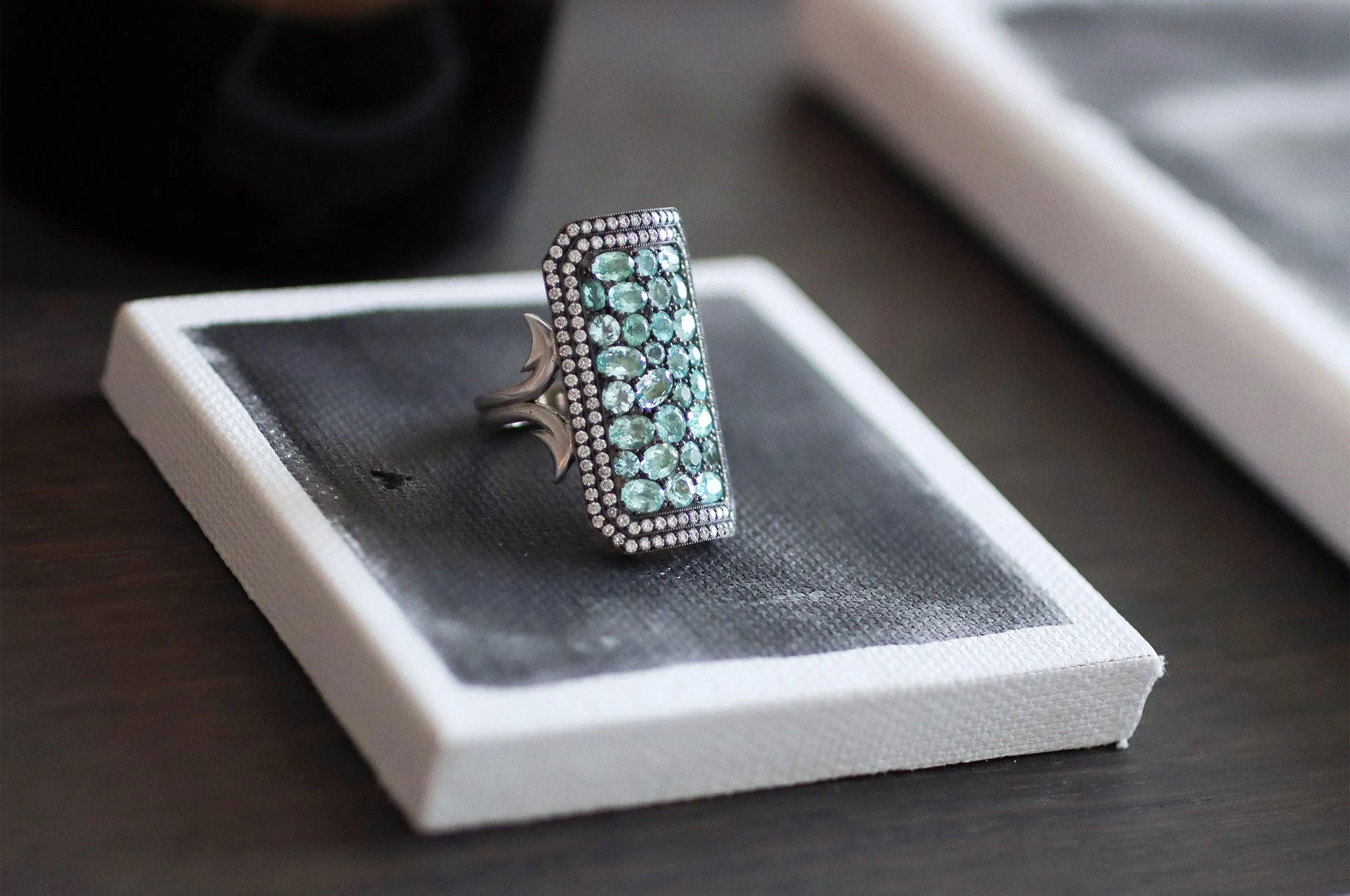 <p>Called the Ten Table because it can be seen from ten tables away, this one-of-a-kind ring is set with oval and round Paraíba tourmalines</p>
