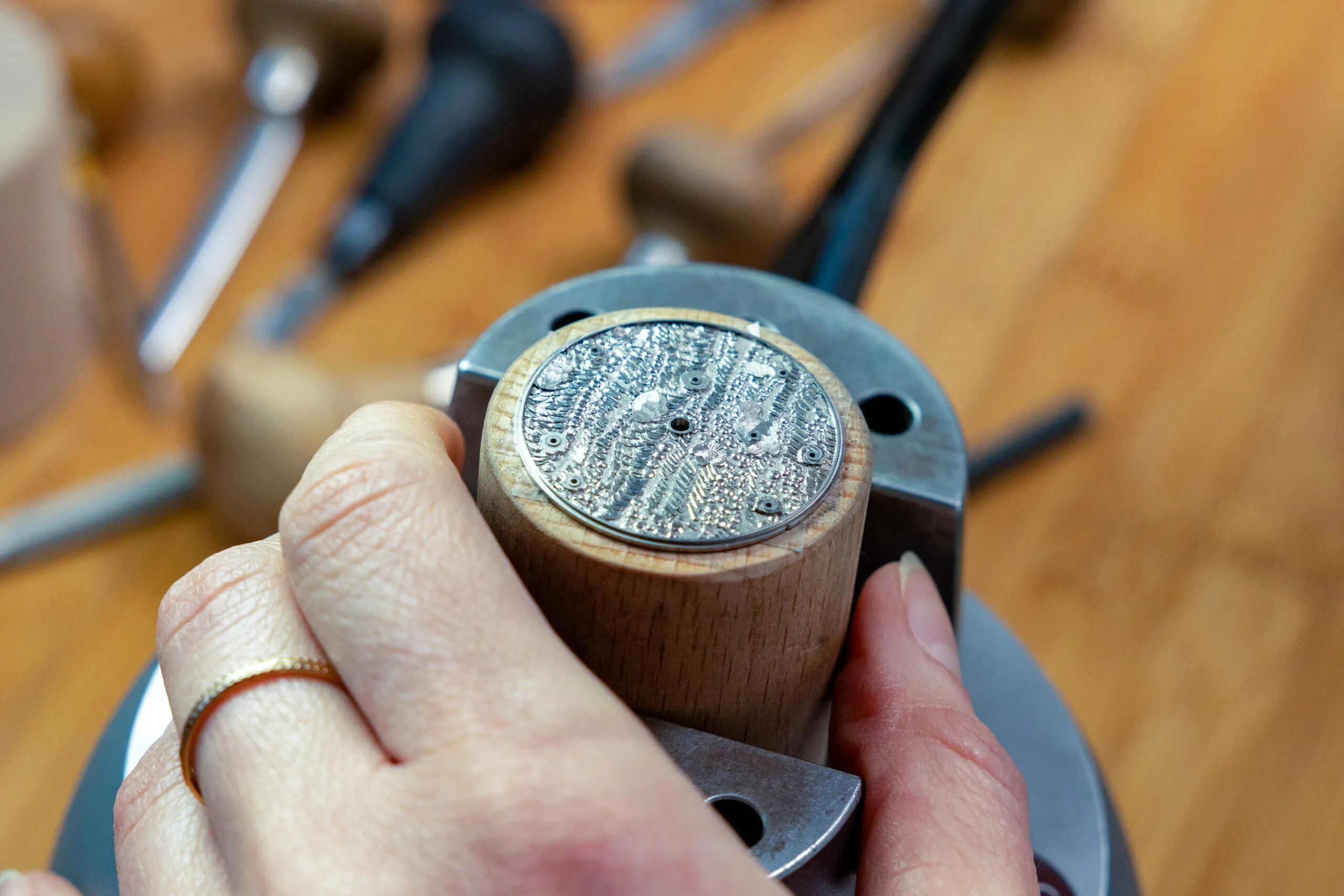 <p>The raised hand-engraved dial that forms the backdrop for the TAOS Sequins watch </p>
