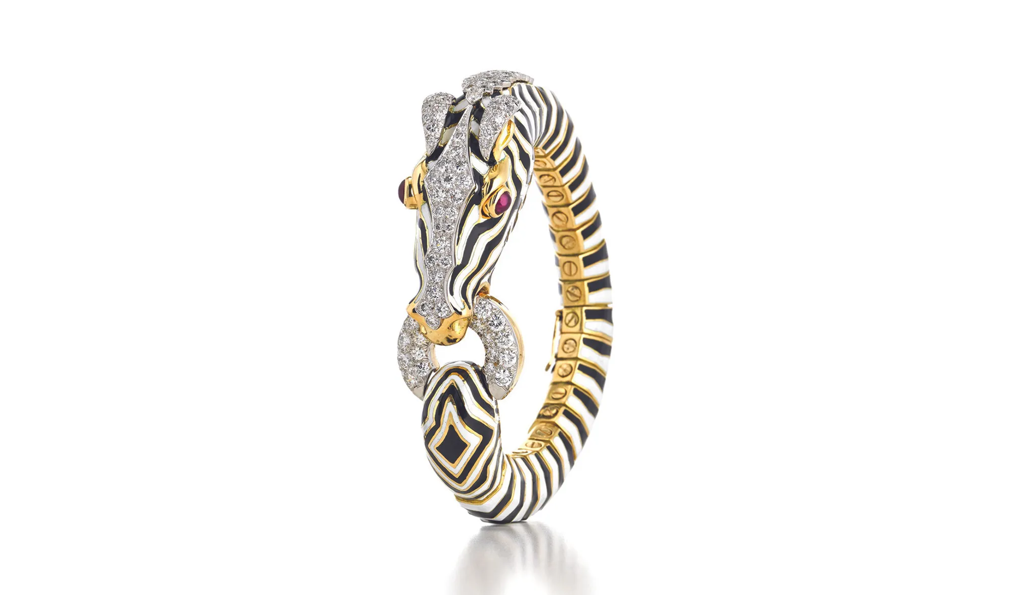 <p>18K gold and platinum ‘Zebra’ bracelet, decorated with black and white enamel and set with cabochon rubies and brilliant-cut diamonds, by David Webb, circa 1960s. Photograph courtesy of David Webb</p>
