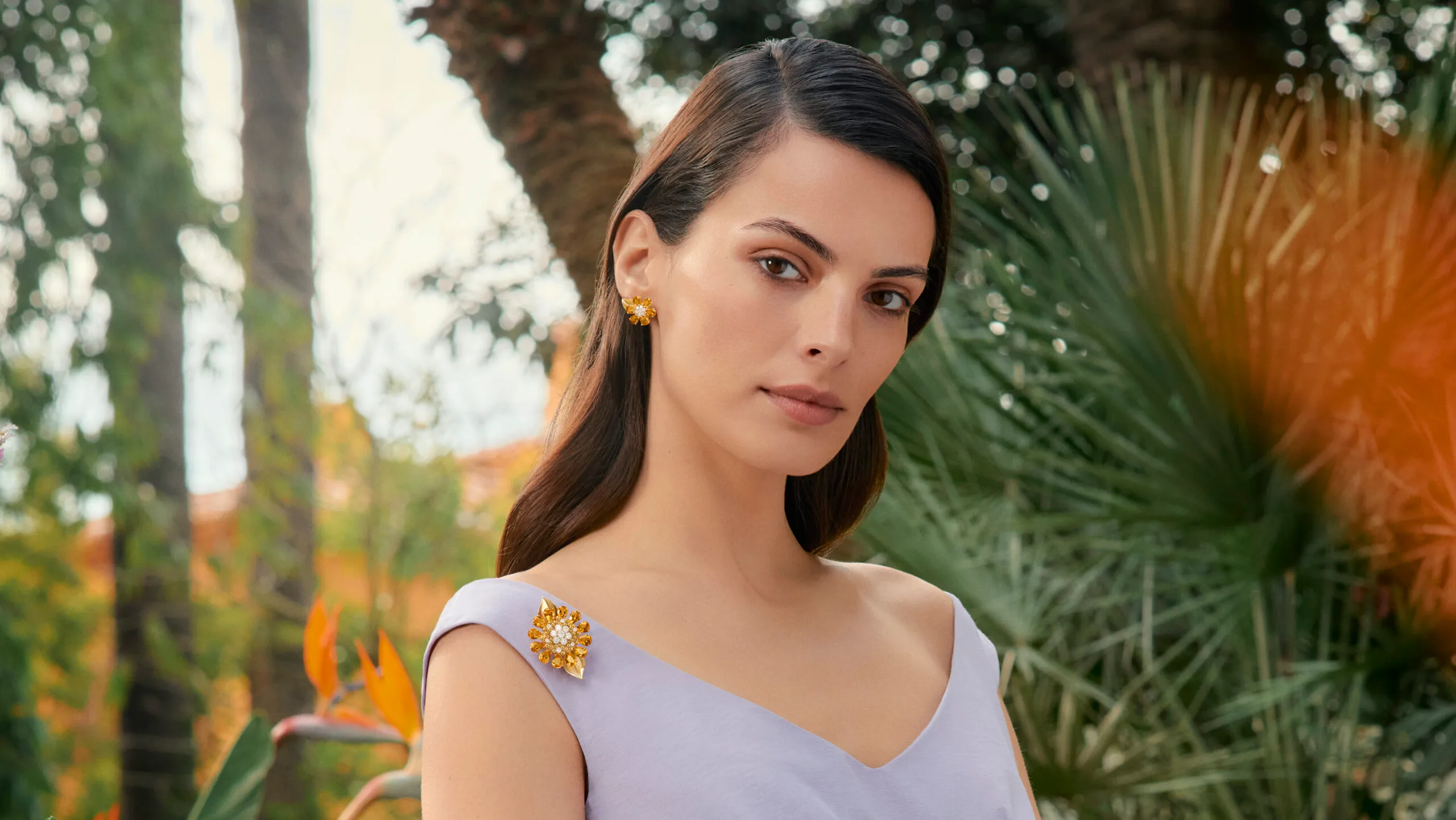 <p>Model wears Van Cleef & Arpels Fleurs d’Hawaï secret watch, which doubles as a brooch or pendant, featuring citrine and diamonds in 18k white gold</p>