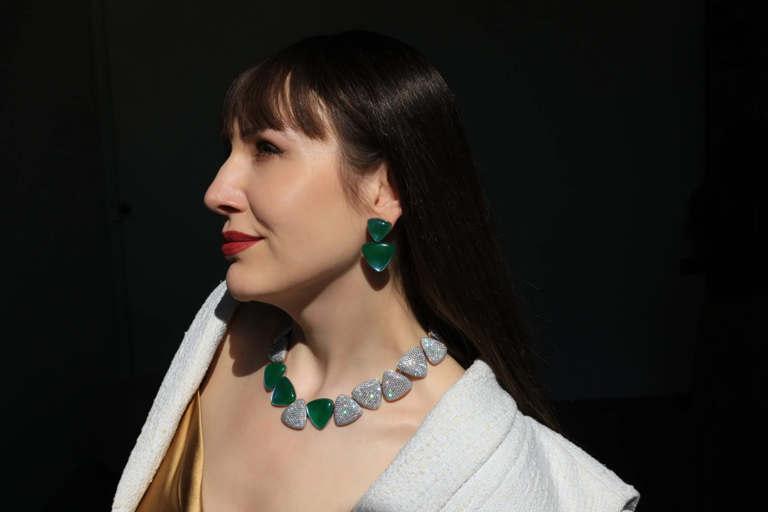 Katerina Perez wears the Vhernier Freccia High Jewellery necklace and matching ear clips, set with jade, rock crystal, mother of pearl and diamonds in white gold 