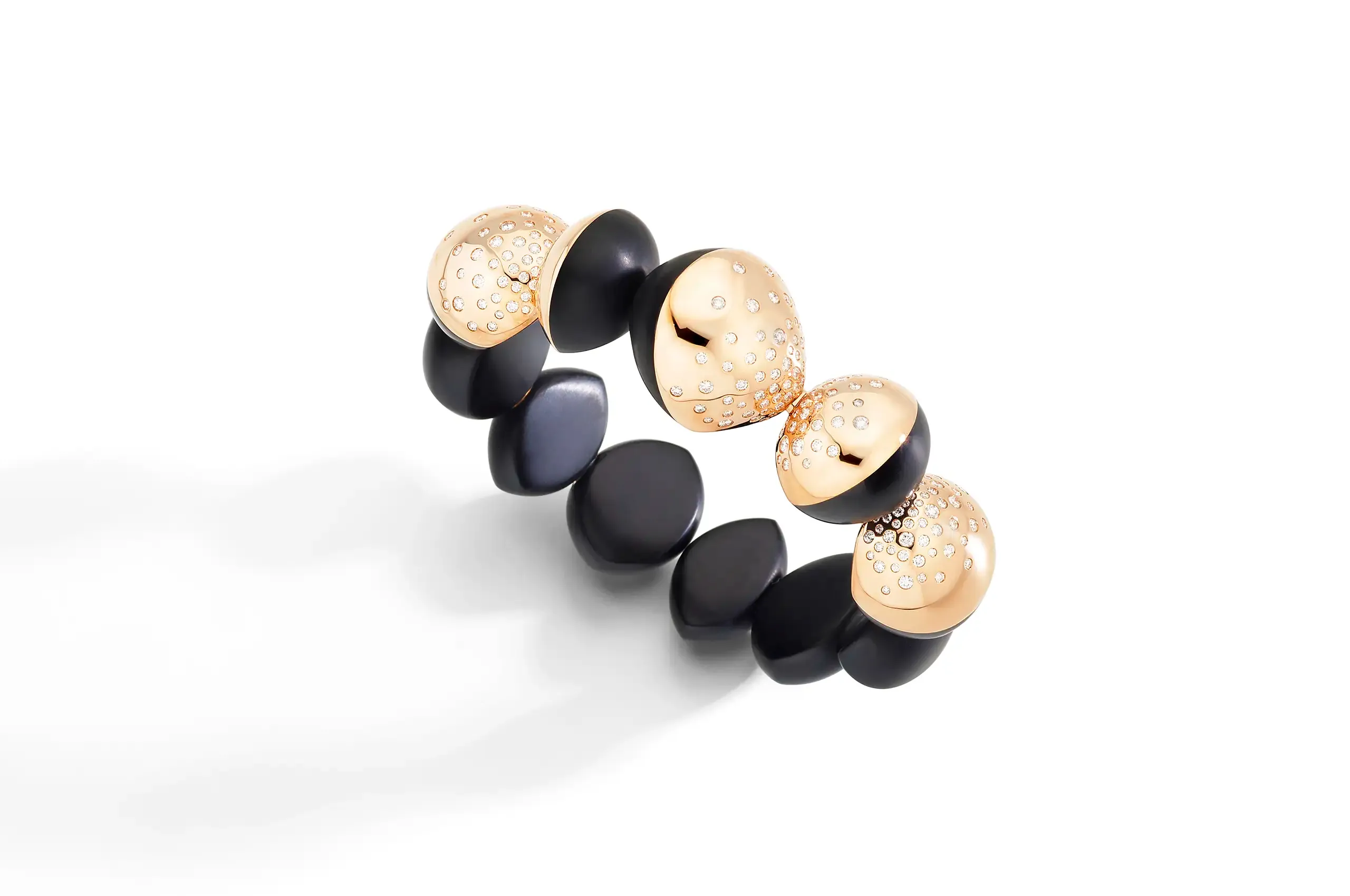 Polished rose gold meets glossy black jet in a study of warmth and depth, giving the renewed Trottola collection its graphic character.