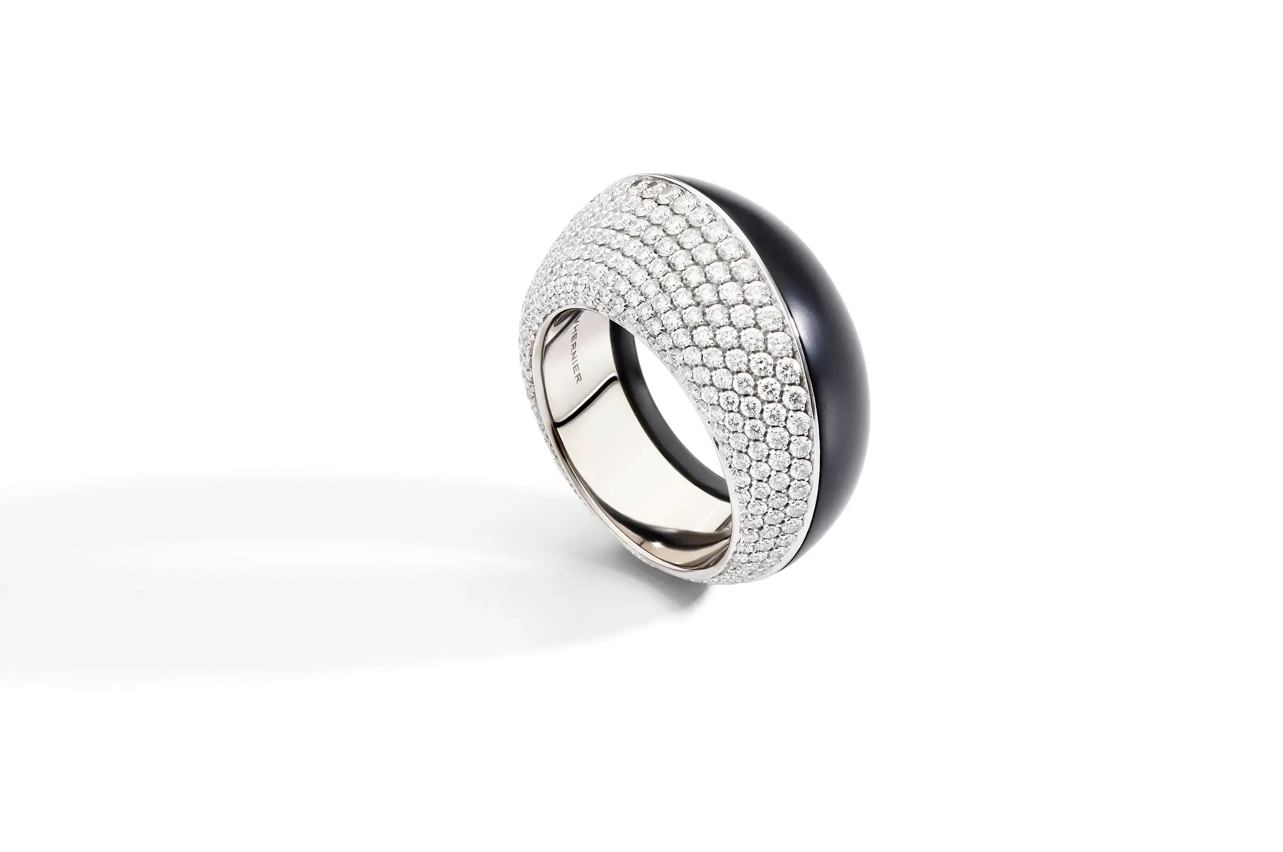 Diamonds are scattered across rose, white gold and jet in select Trottola creations.