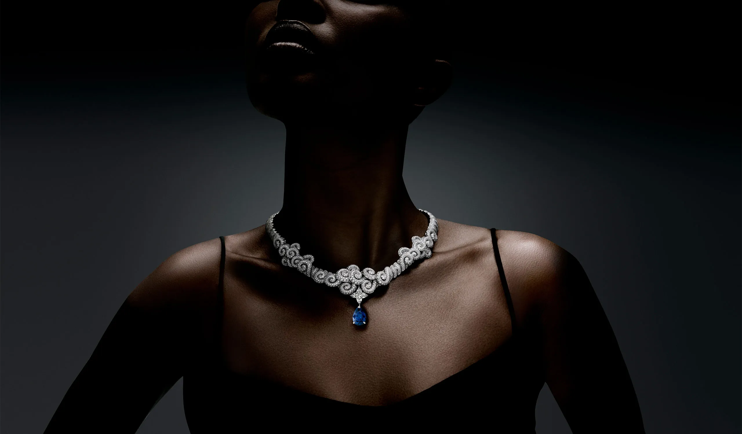 <p>Diamond-set whorls sweep towards an 11.56ct royal blue pear-shaped step-cut sapphire in the Whisper high jewellery necklace</p>
