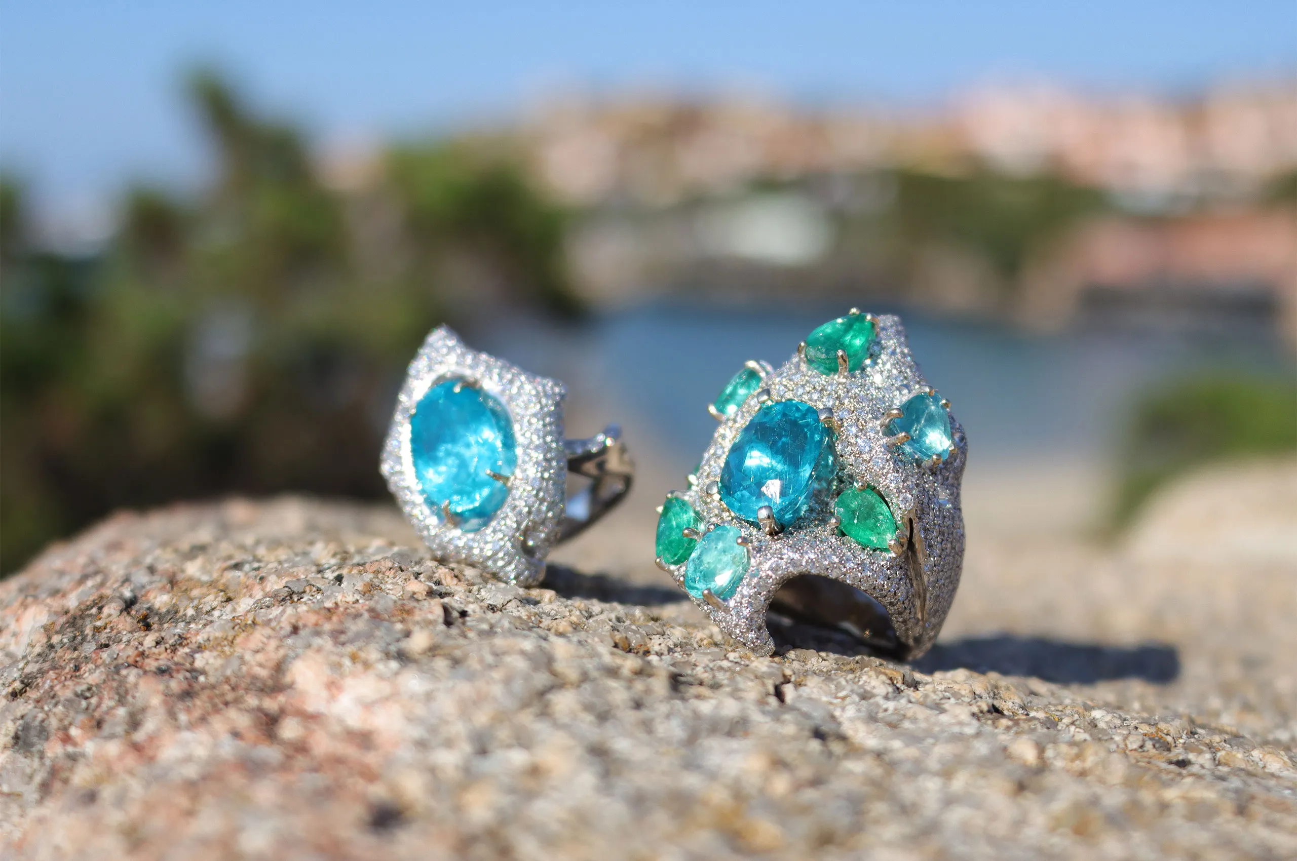 On the left, an oval apatite is showcased in a sculptural ring entirely pavéd in natural diamonds