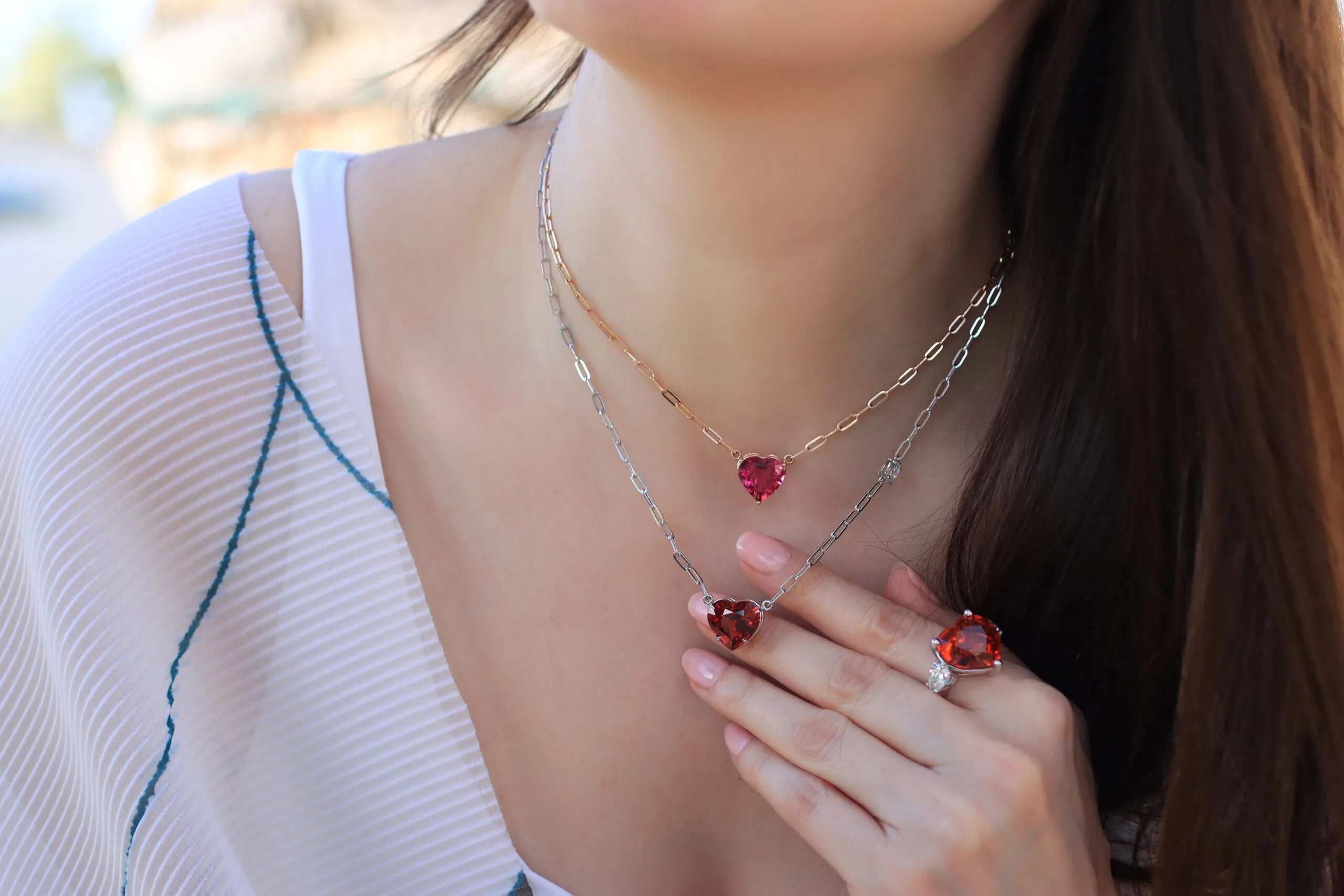 <p>Katerina Perez wears a selection of heart-shaped gemstone pendants from the Rocks collection by Lisa Nik</p>
