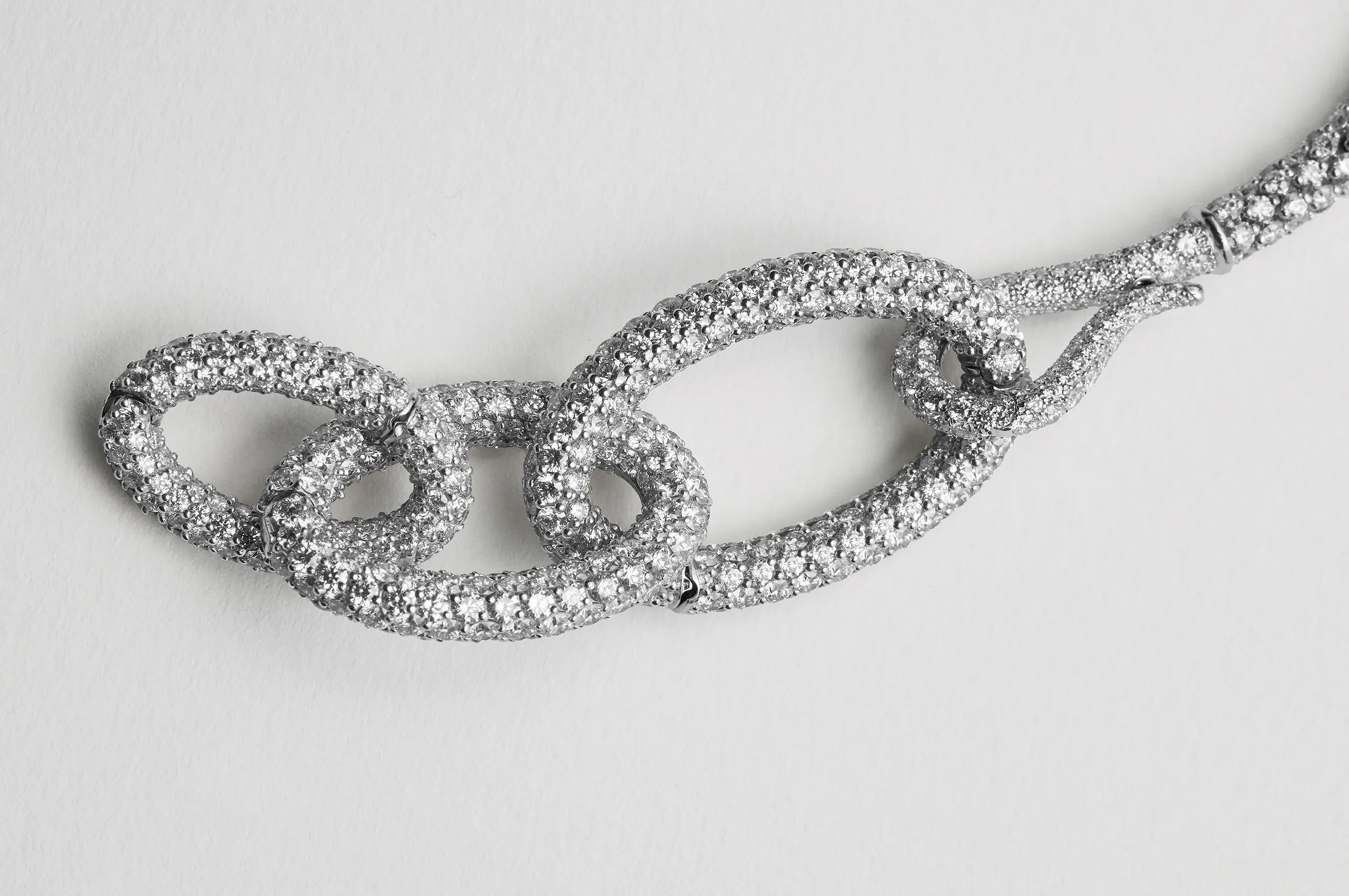 A close up of VESCOVI's ODEA suite Aura platinum clasps with white diamonds