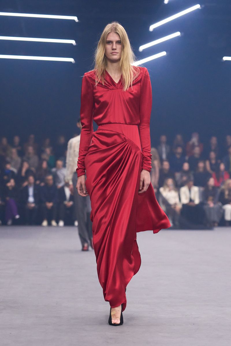 A model wears a striking red dress from the Valentino SS26 collection