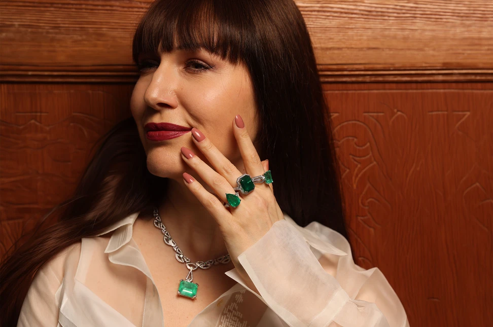 Katerina wears emerald high jewellery by Bachtale showcasing richly saturated emeralds