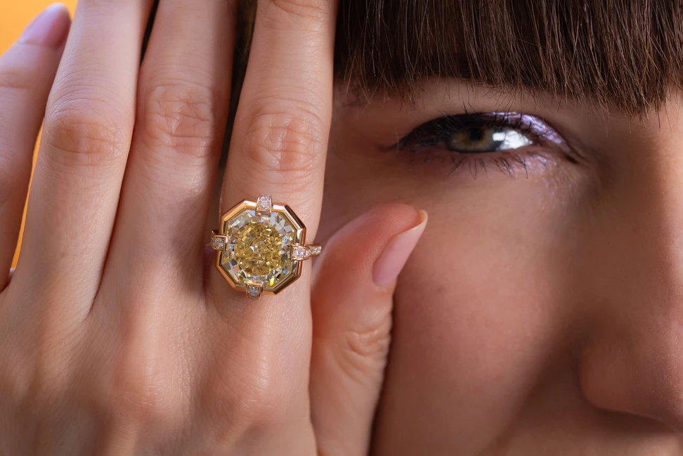 Katerina wears Bayco’s 10.04-carat Fancy Intense Yellow diamond ring, its substantial octagonal gold setting softened by delicate diamond-set shoulders