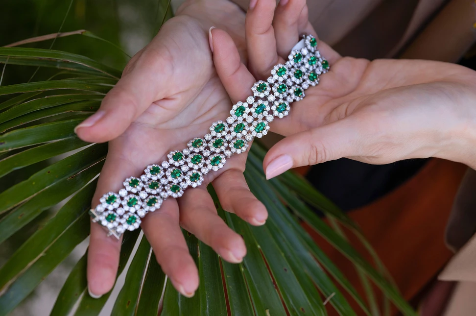 Oval Zambian emeralds encircled by diamonds form a repeating cluster motif across this extraordinary Bayco bracelet, set with 42 carats of gemstones