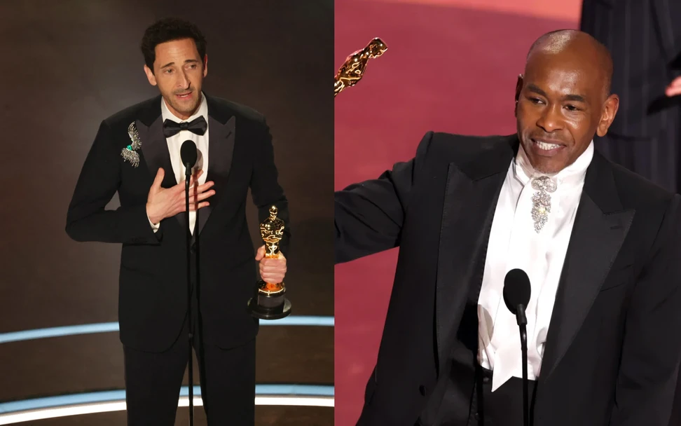 <p>Adrian Brody wearing a brooch by Elsa Jin and costume designer Paul Tazewell in a diamond and platinum brooch (c. 1950) from Fred Leighton, set with more than 45 carats of round and baguette-cut diamonds at the 97th Annual Academy Awards 2025</p>