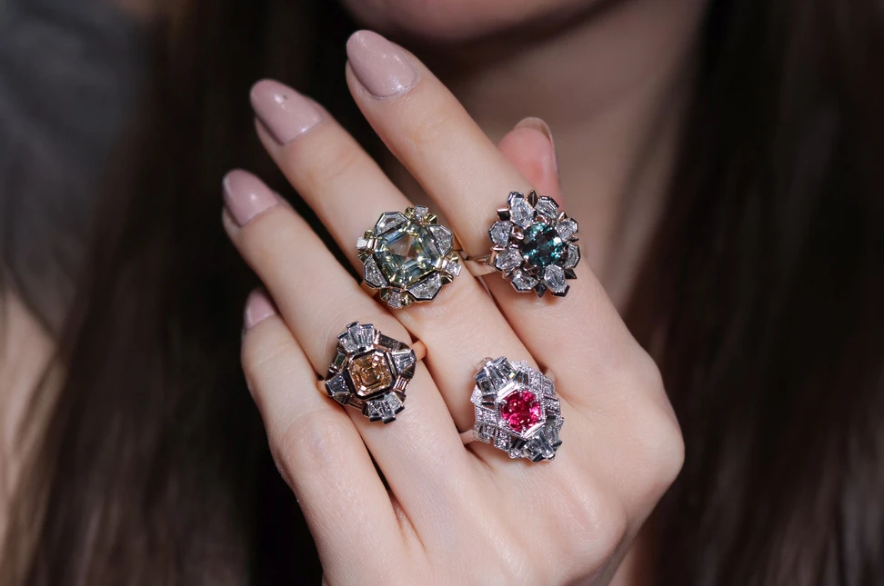 Katerina Perez wears a selection of rings by Artisans Bespoke Jewellers, including (from left to right) the Empire Solis ring with 3.05 carats of Asscher- and baguette-cut diamonds in 18k rose gold and platinum; a second Empire Solis ring with a 5.60 carat Asscher-cut yellow sapphire and 1.05 carats of diamonds in 18k yellow and white gold; the Empire ring with a 1.80 carat red spinel and 0.70 carats of diamonds in 18k white gold, and the Tsarina ring with a 2.28 carat cushion-cut alexandrite and 1.62 carats of diamonds in platinum and 18k rose gold 